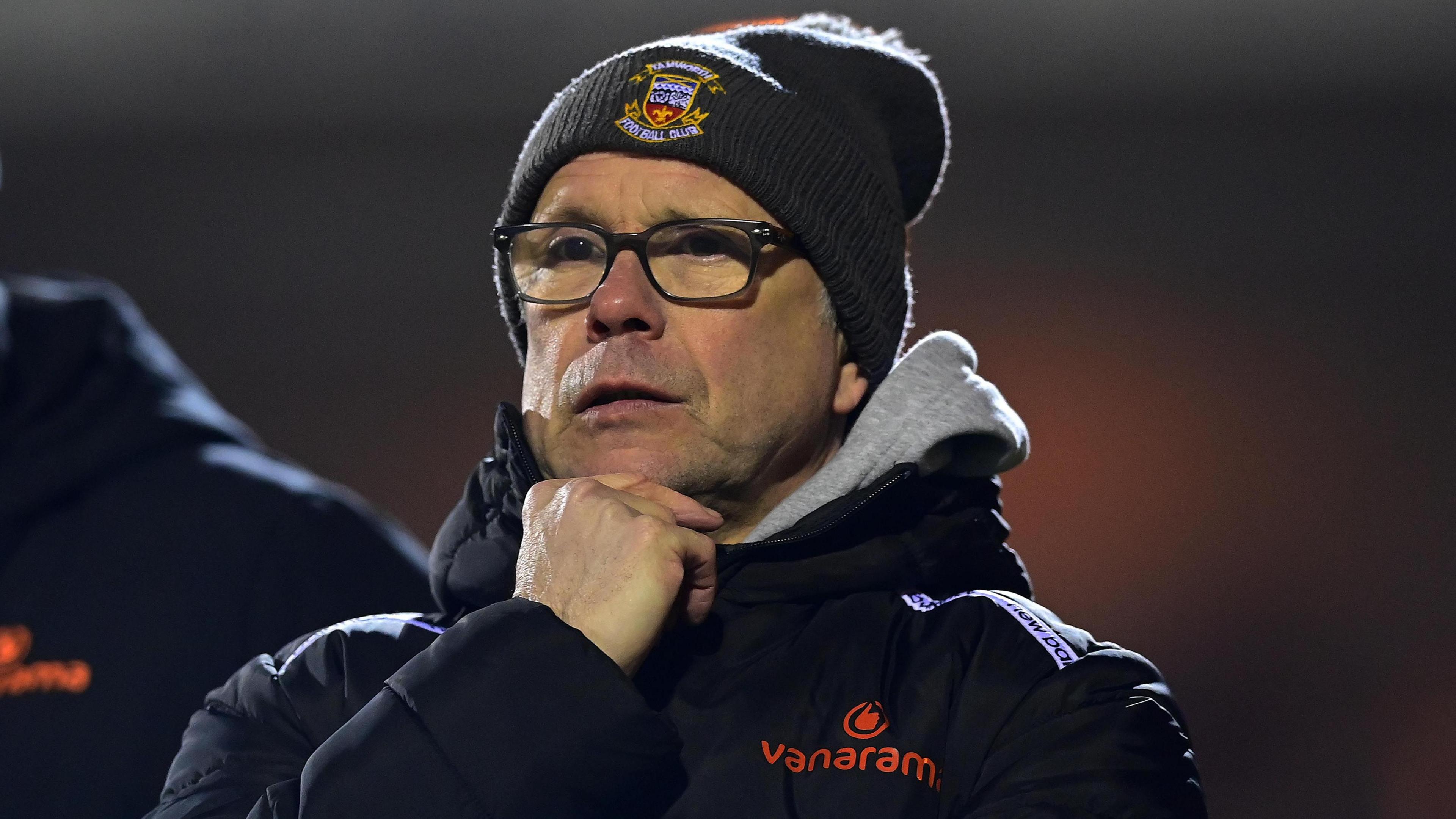 Tamworth manager Andy Peaks in his beanie watching on from the touchline