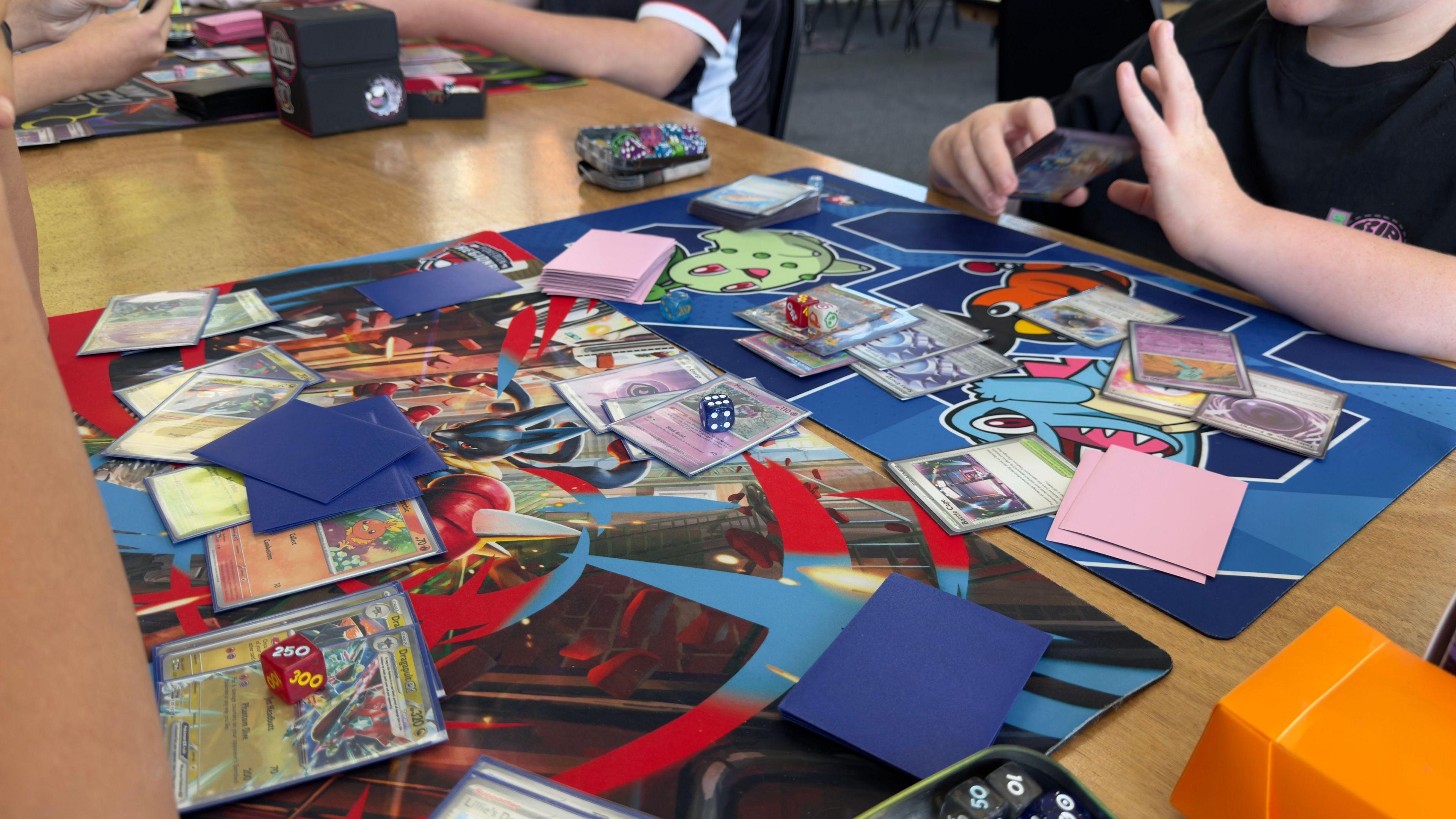 A Pokémon trading card game on a table at a gaming café in Nottingham.