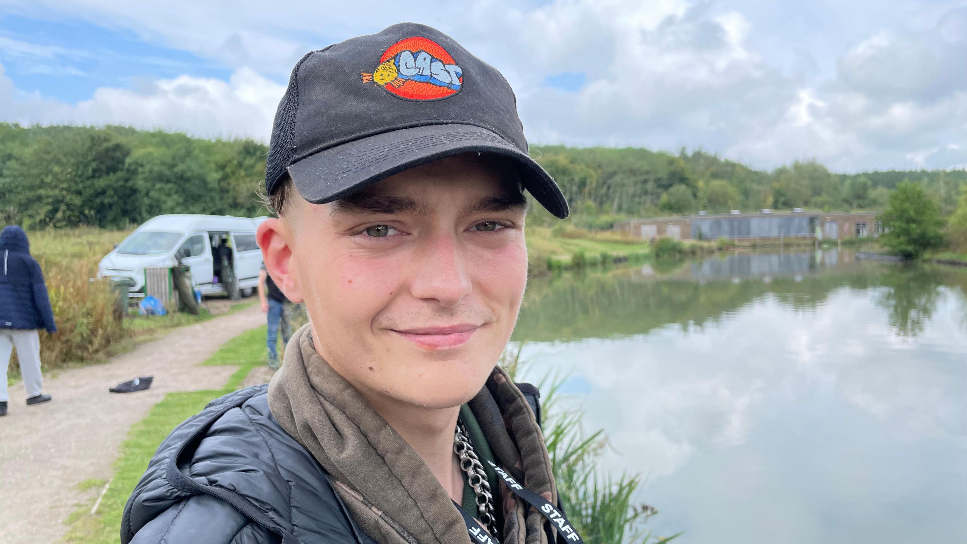 Nico Blade-Smith wears a black baseball cap with the Cast logo - an orange circle featuring the world "Cast" written in blue.