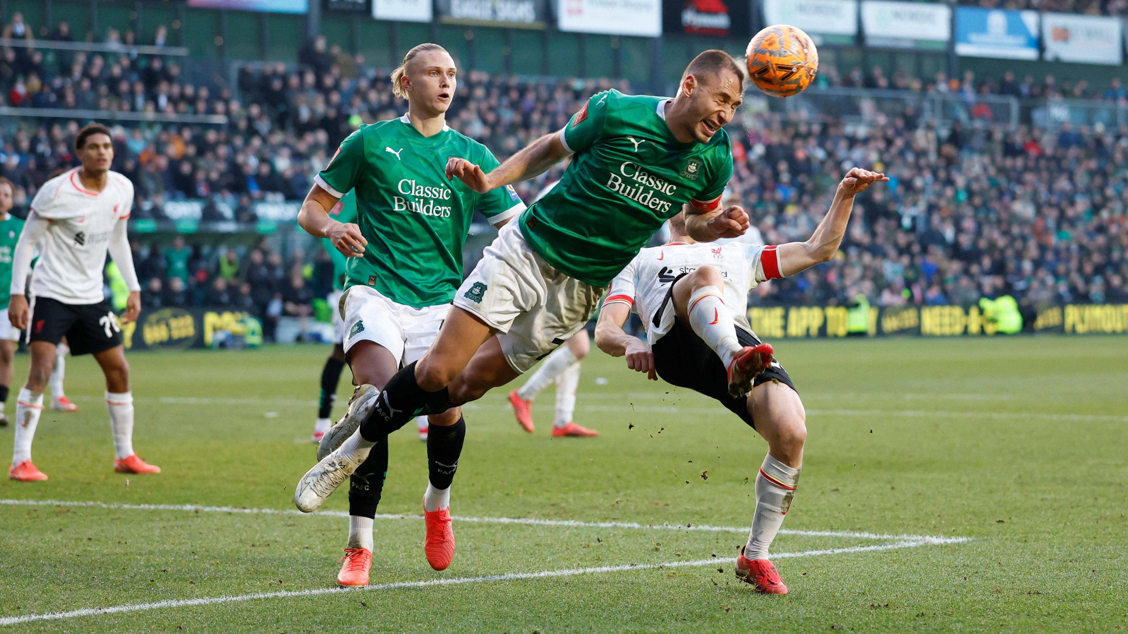 Nikola Katic heads clear for Plymouth against Liverpool