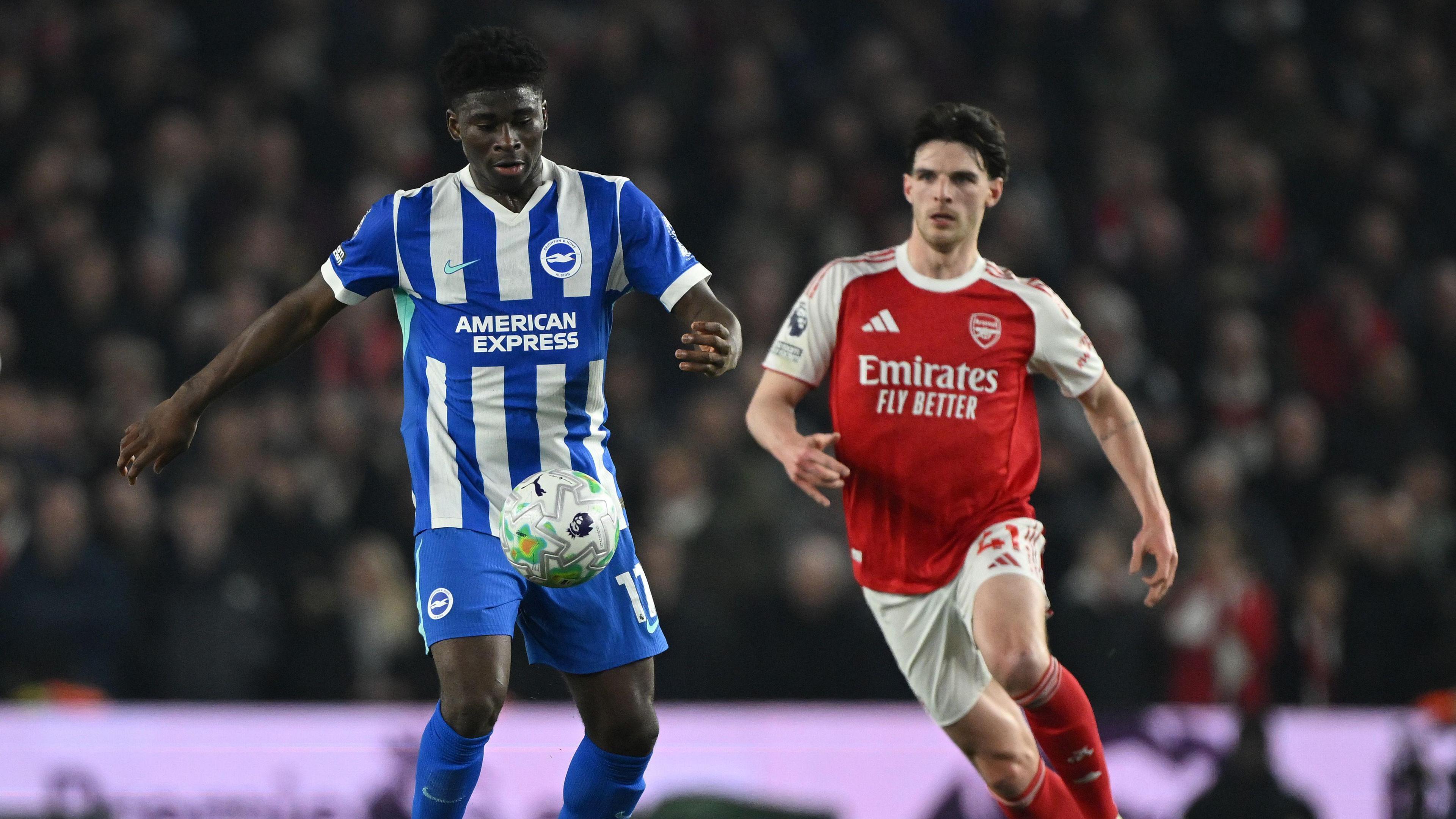 Carlos Baleba playing for Brighton and being challenged for the ball by Arsenal's Declan Rice