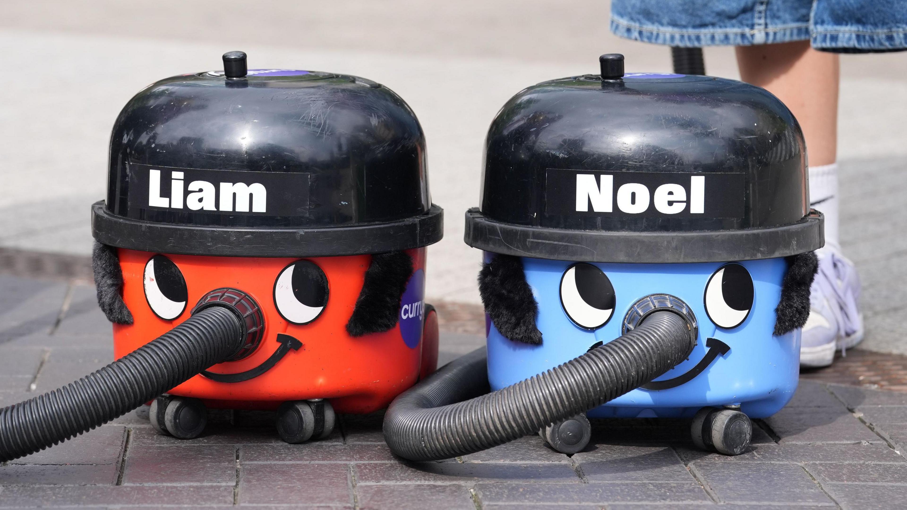 A fan displays customised Henry Hoovers in blue and red named after Liam and Noel Gallagher.