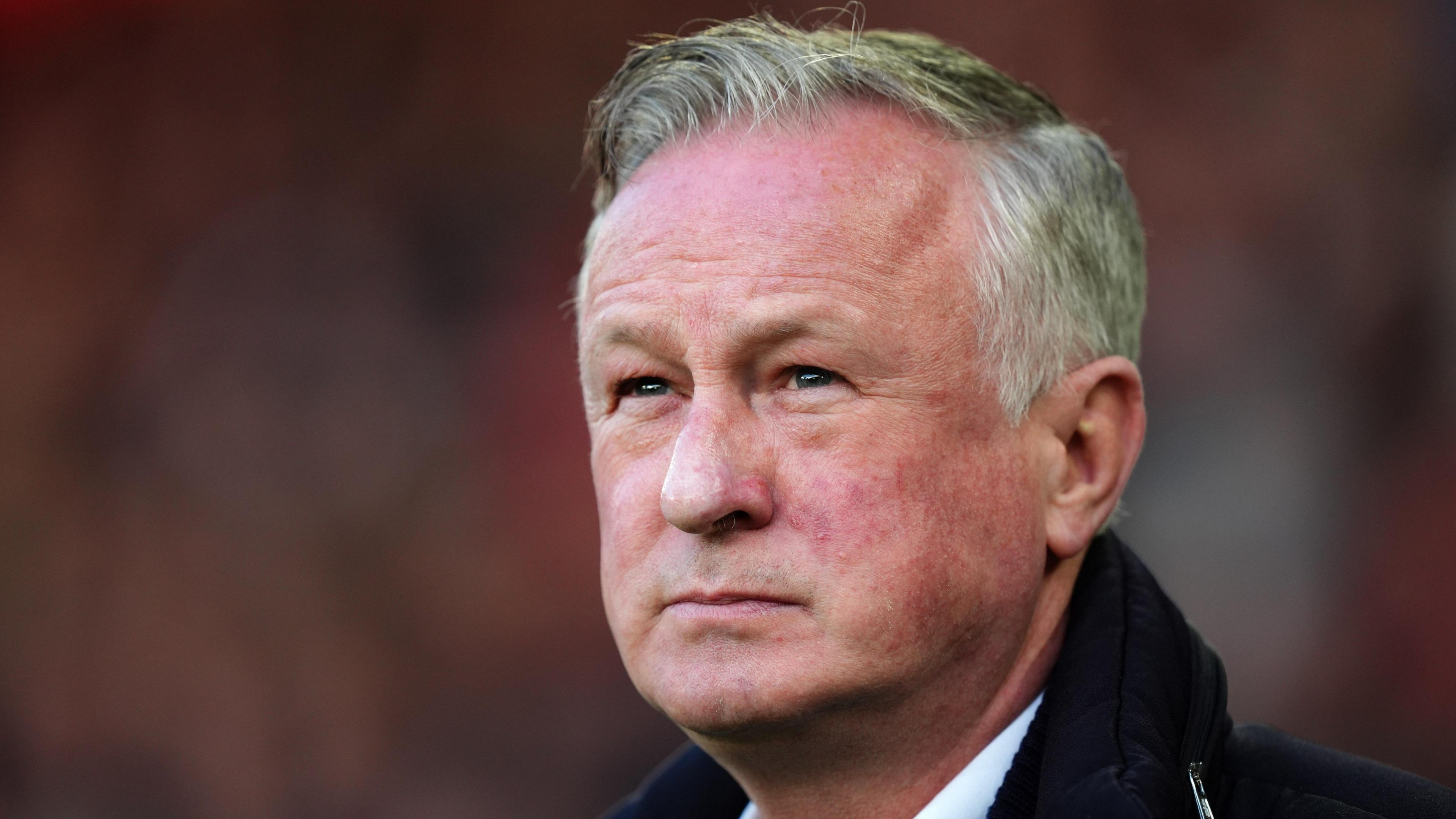 Michael O'Neill, wearing a black jacket and white shirt, on the touchline at Bramall Lane during Blackburn's game against Sheffield United