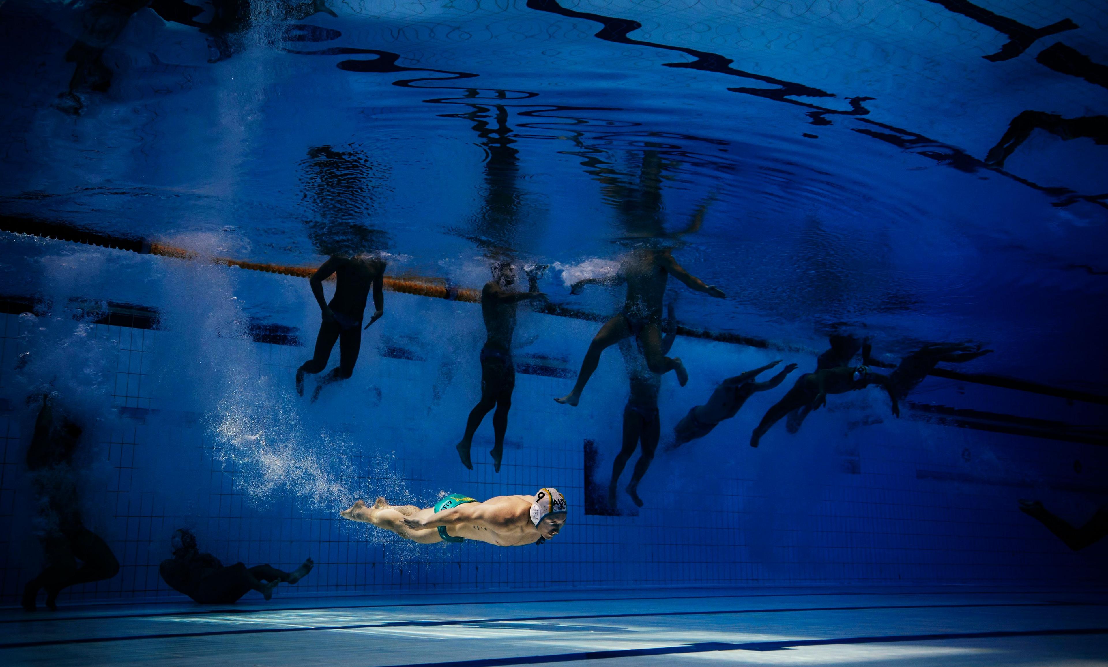 Australia's Matthew Byrnes jumps into the water before the preliminary round water polo match against Japan at the World Aquatics Championships in Singapore