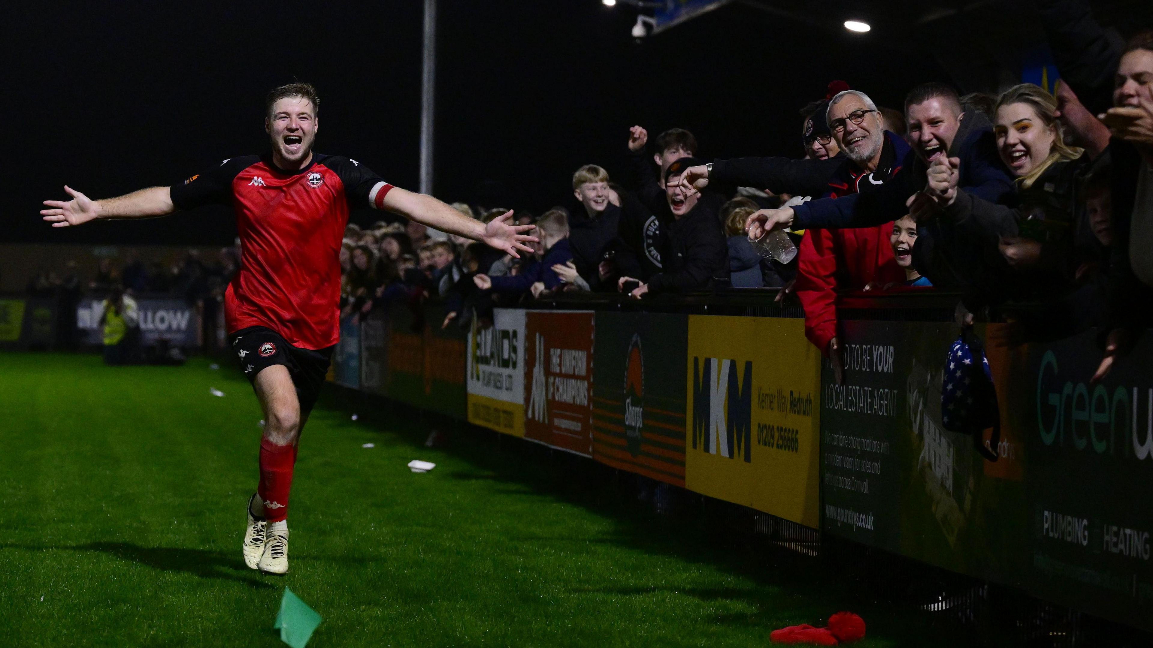 Truro City fans celebrate a goal