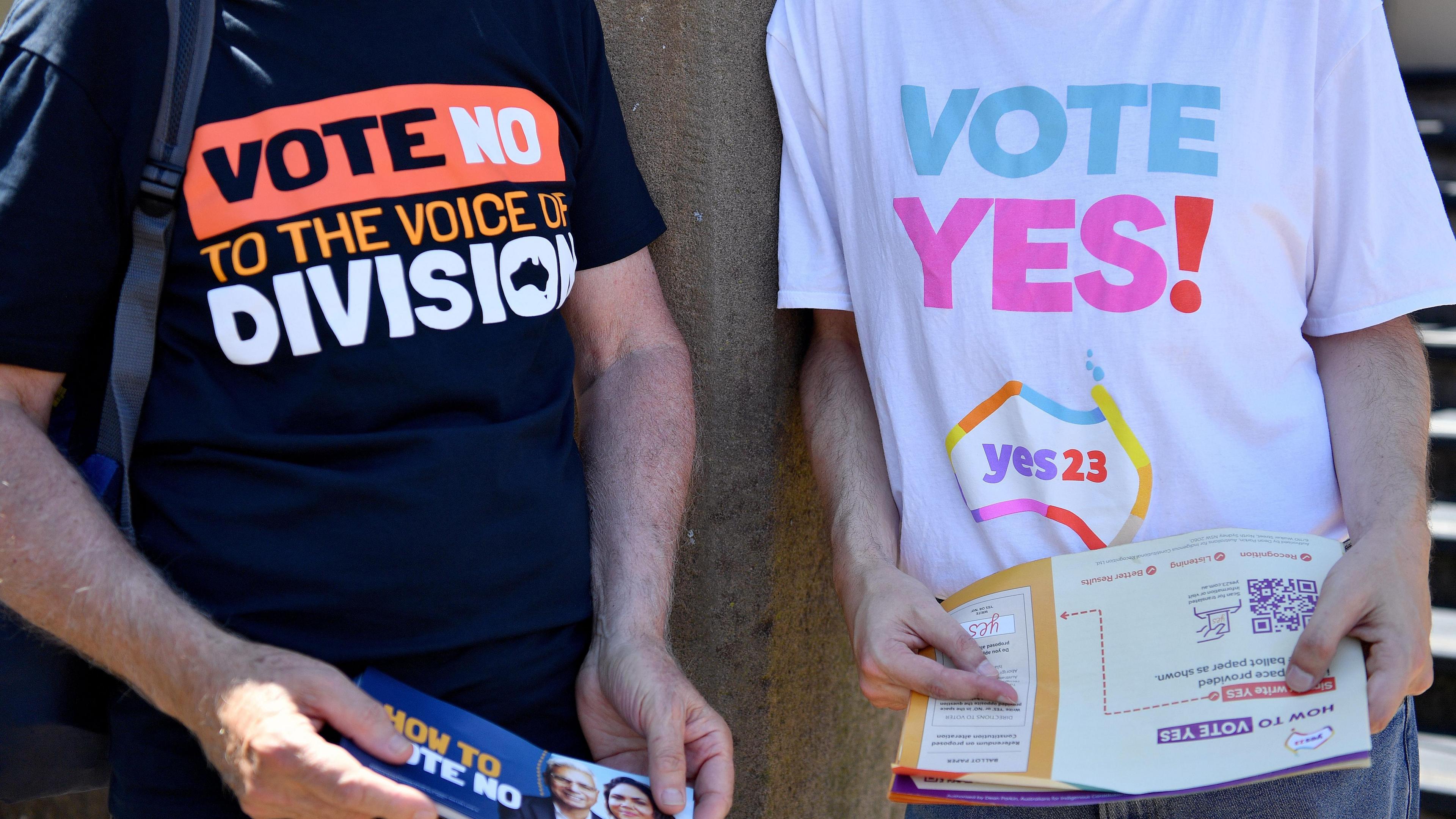 Campaigners from both the 'No' and 'Yes' camps in Australia's Voice to Parliament referendum hand out fliers in front of polling stations 