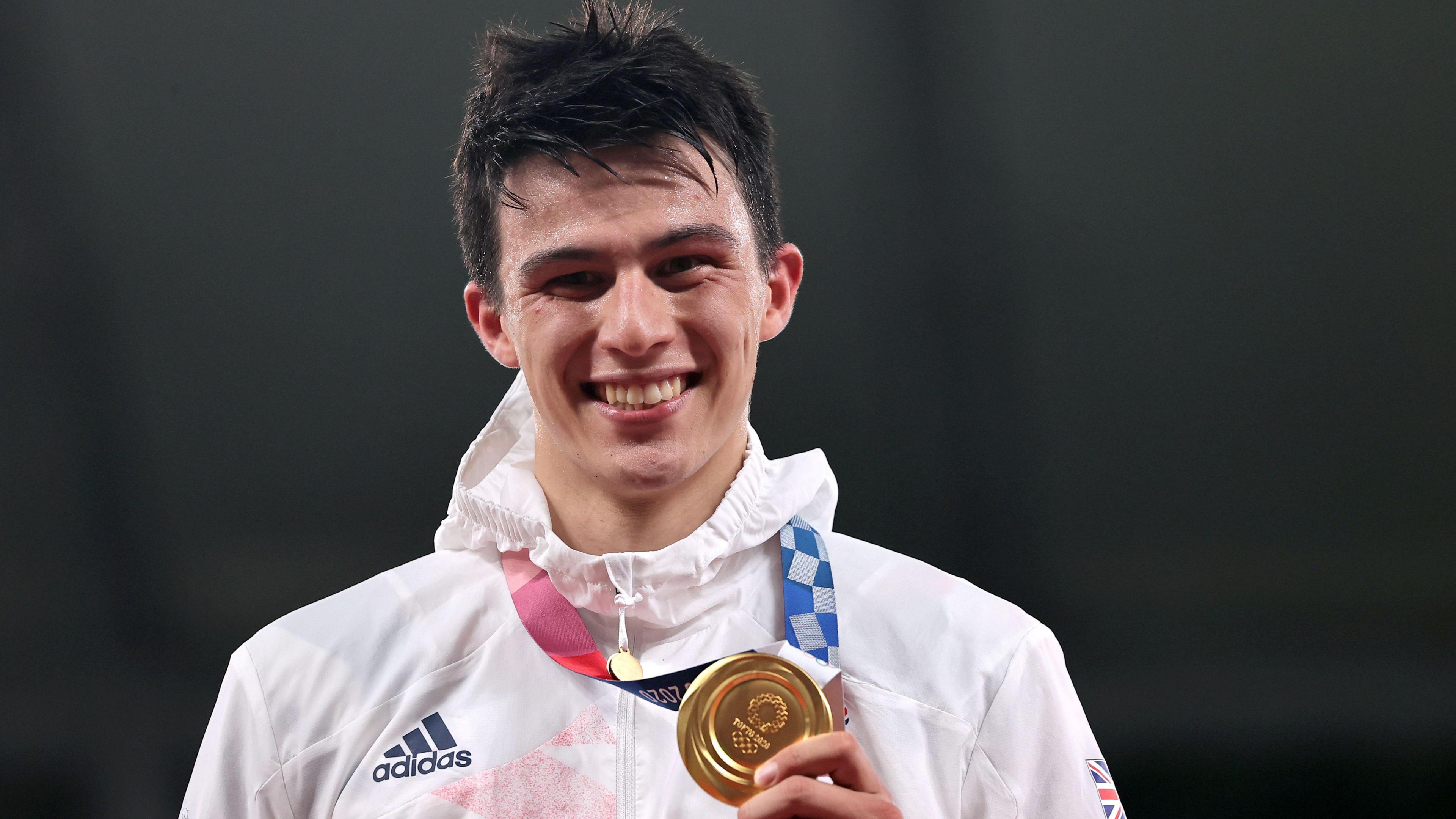 Joe Choong on the podium at the Tokyo Olympics with his gold medal