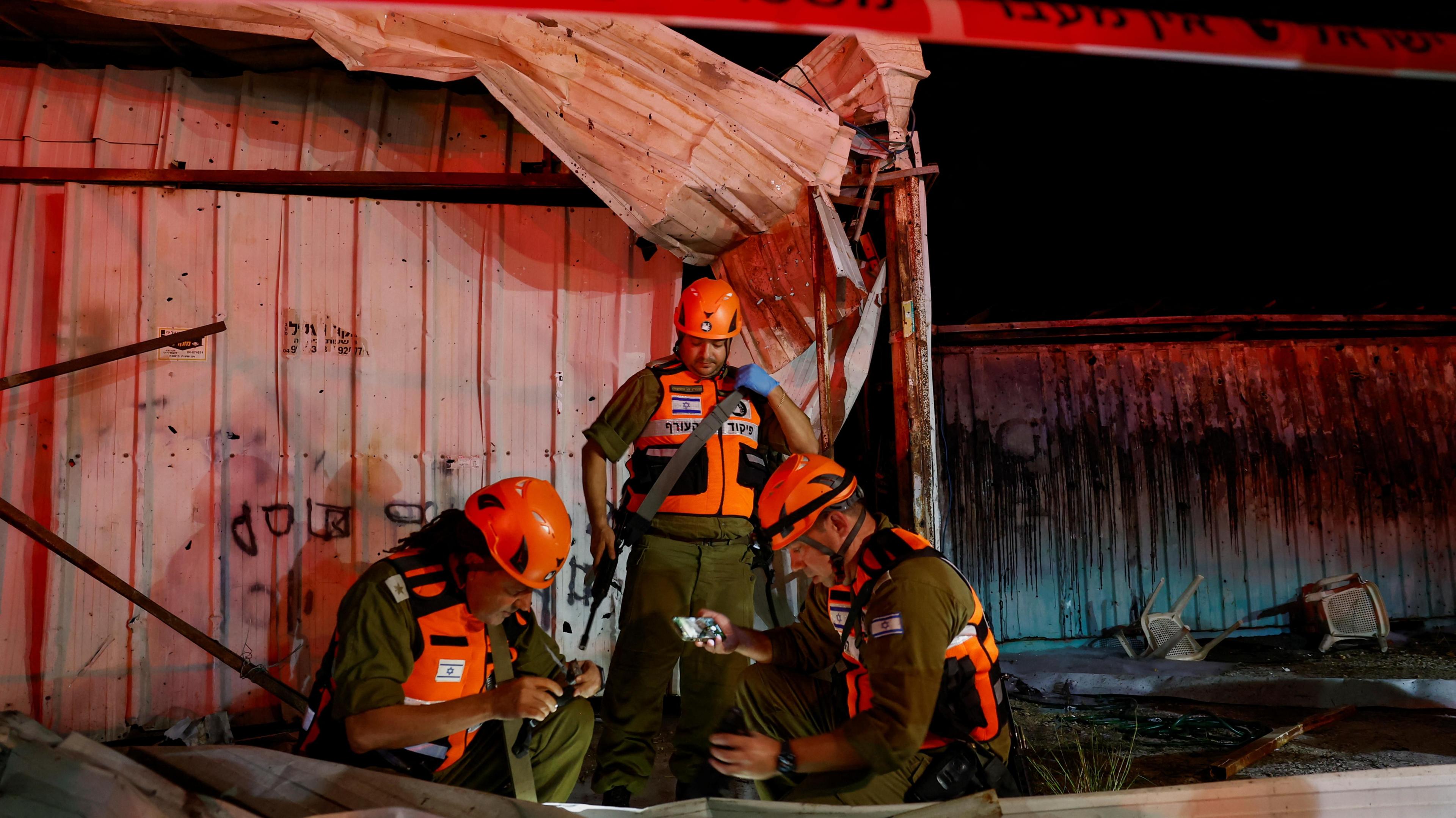 Israeli security personnel investigate the scene of a deadly Hezbollah rocket attack in Nahariya, northern Israel (12 November 2024)