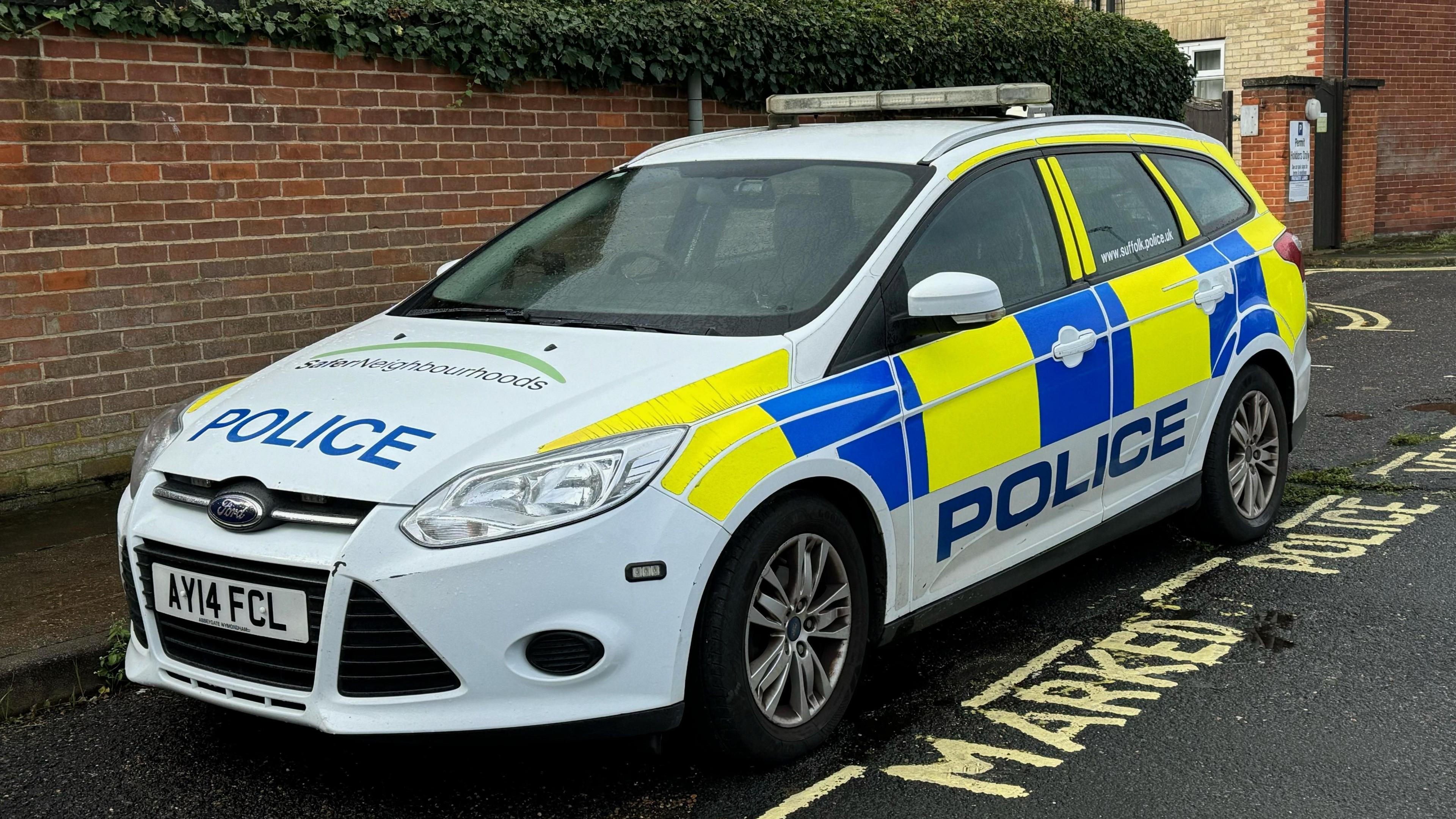 A Suffolk Police car parked in the road