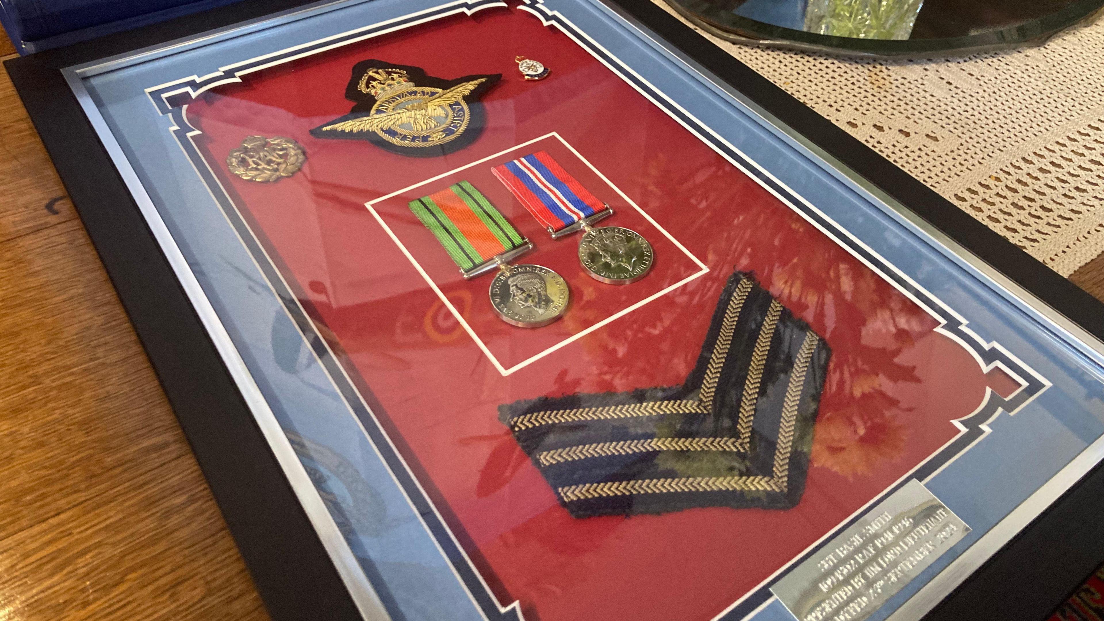 Mr Smith's medals in a frame with RAF patches and insignia