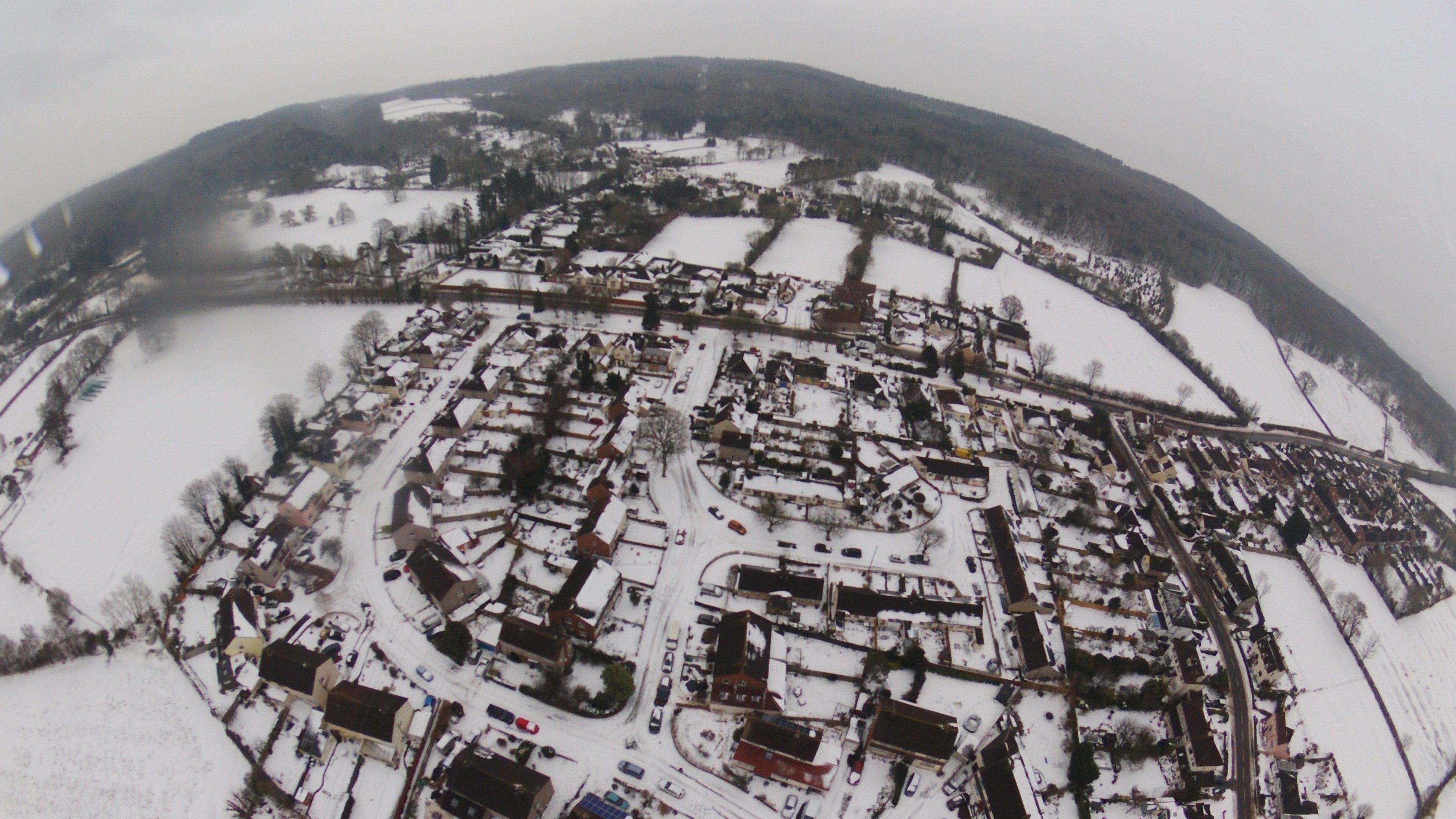 An aerial photo looking down at a snow-covered rural village and surrounding landscape in the West country. Similar scenes are possible by late Saturday, especially across Gloucestershire.