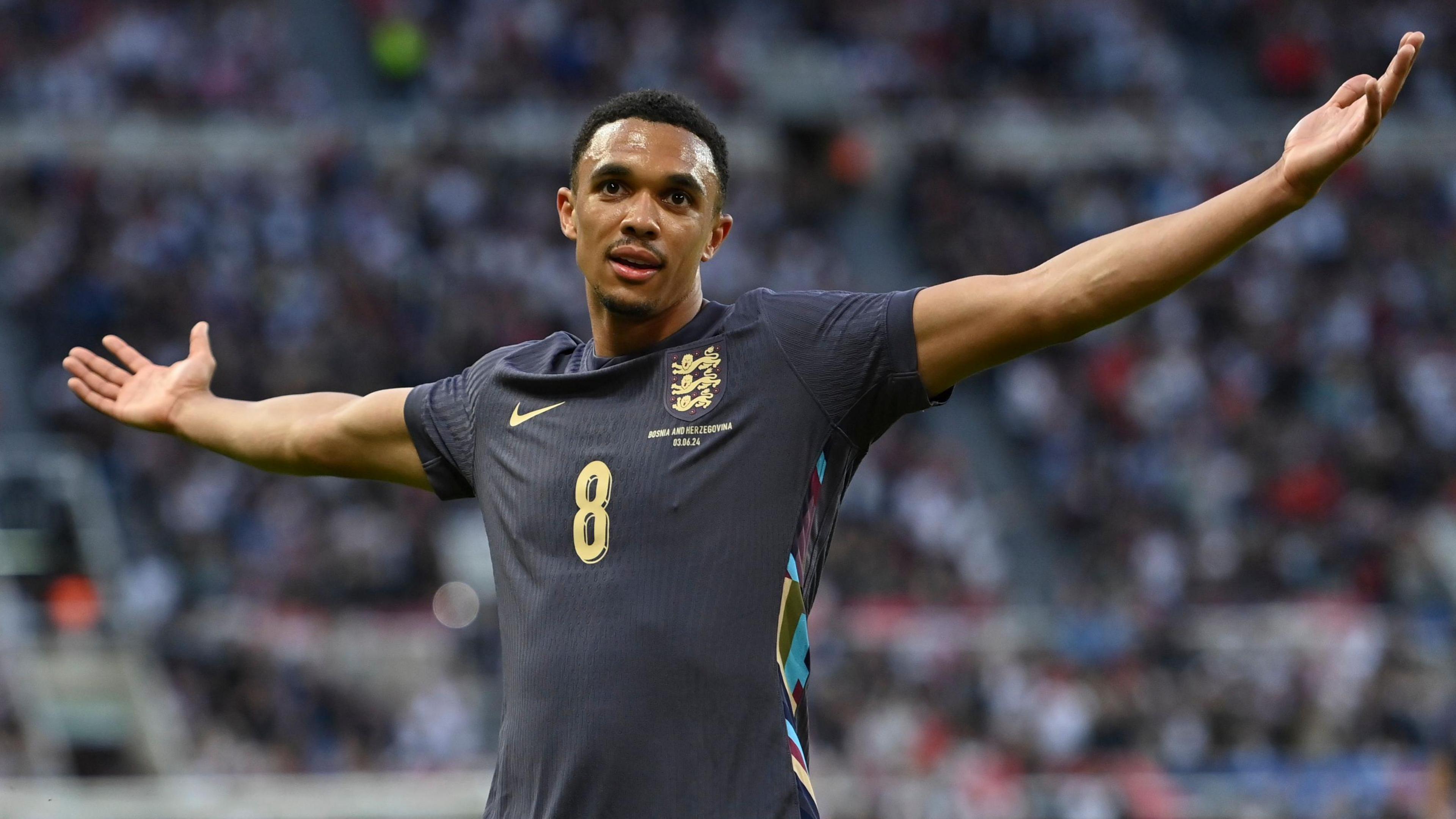 Trent Alexander-Arnold holds his arms out in a celebratory pose