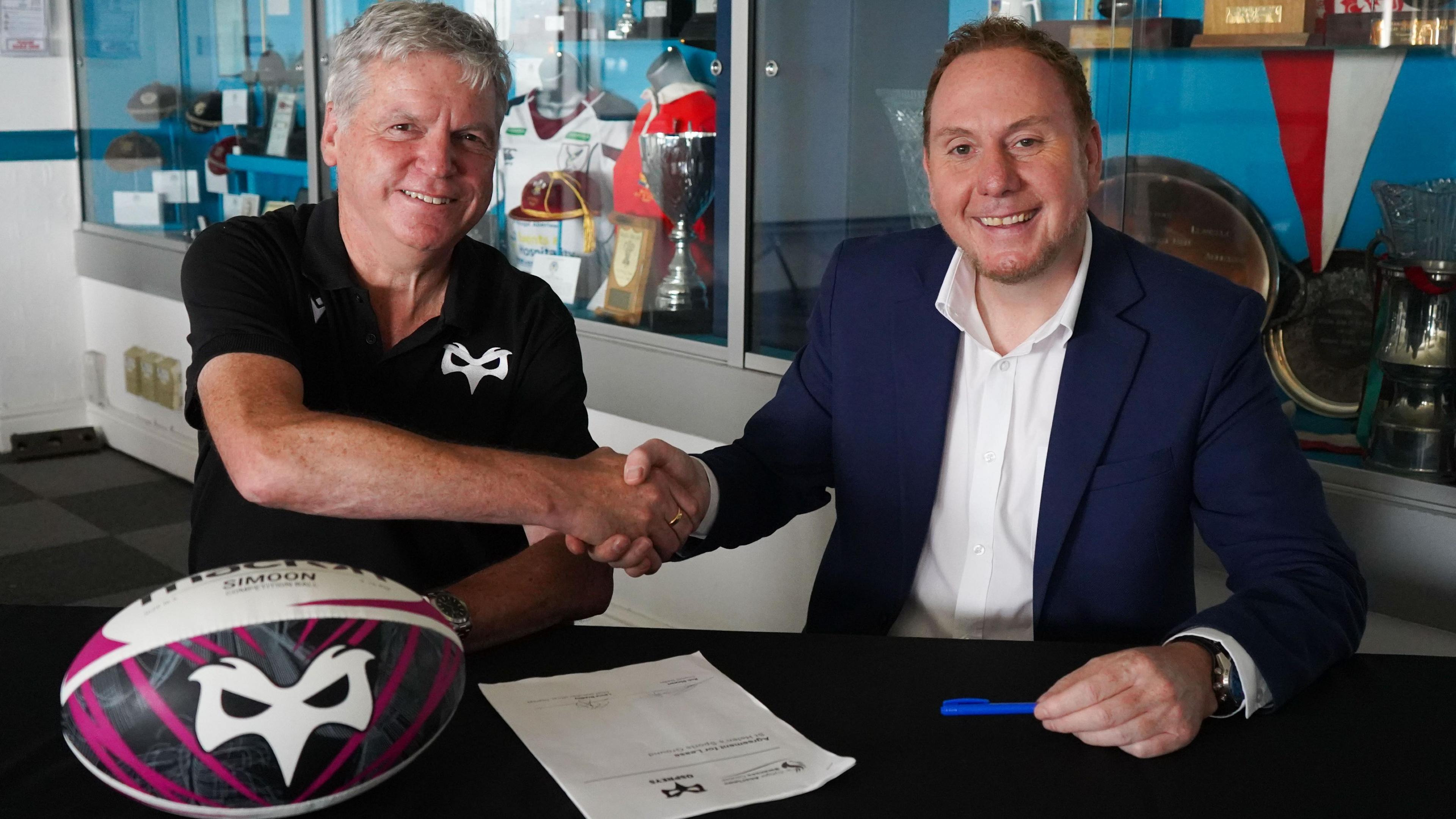 Ospreys chief executive Lance Bradley shakes hands with Swansea Council leader Rob Stewart after agreeing to finalise a deal on the St Helen's lease