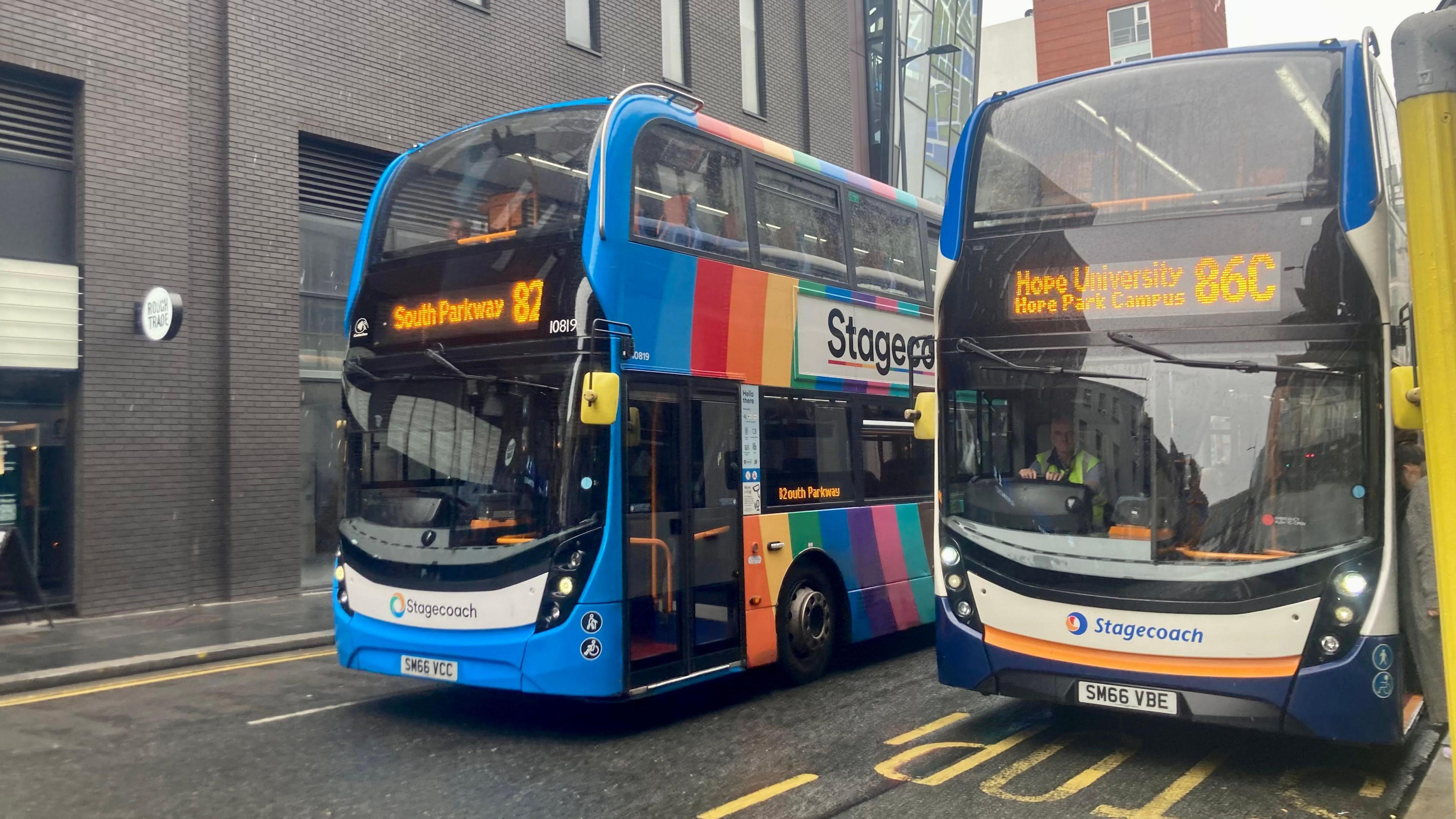 Two double-decker Stagecoach buses with blue liveries line up at a bus station on a street in Liverpool