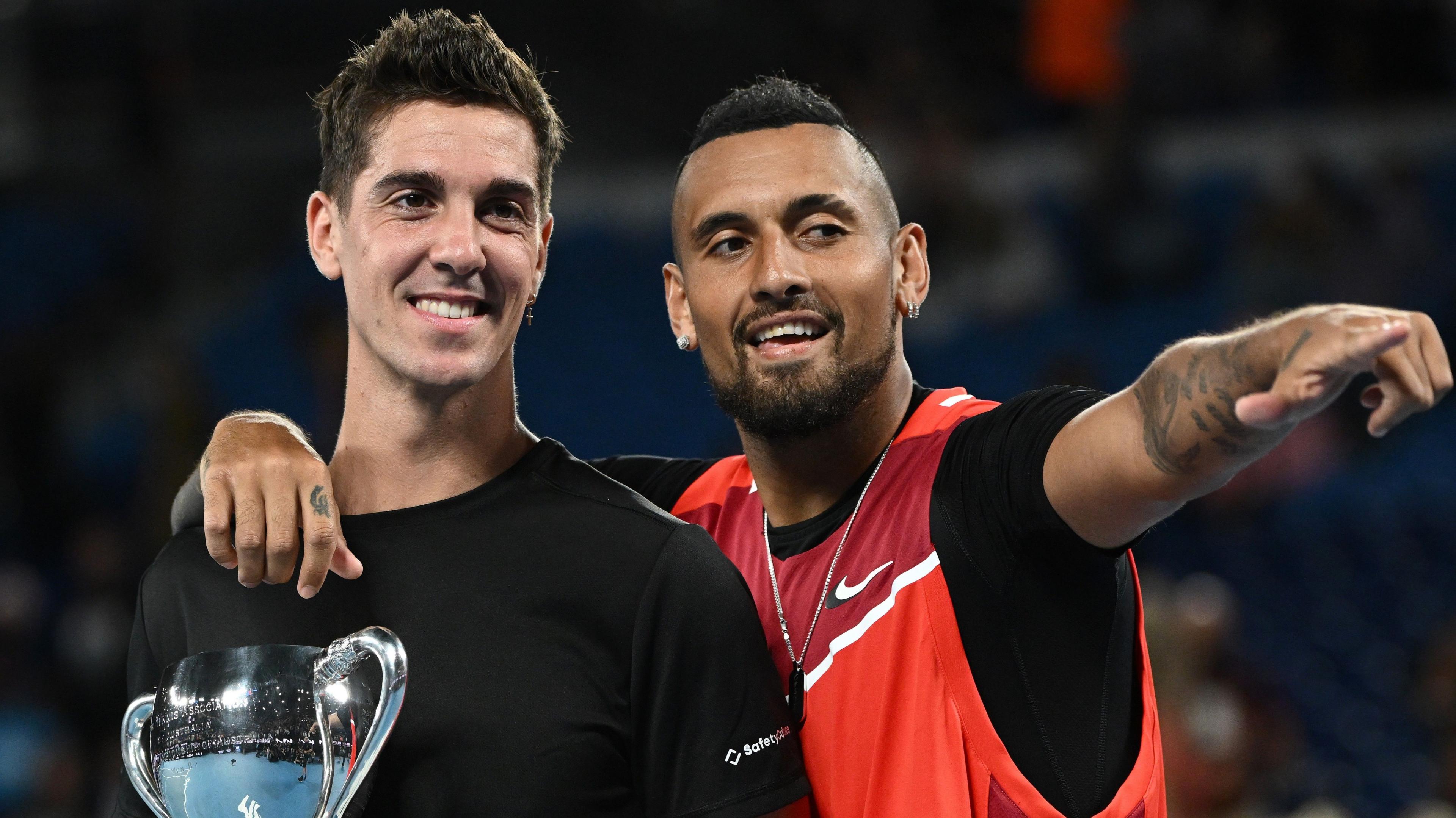 Nick Kyrgios and Thanasi Kokkinakis pose after winning the Australian Open men's doubles title in 2022
