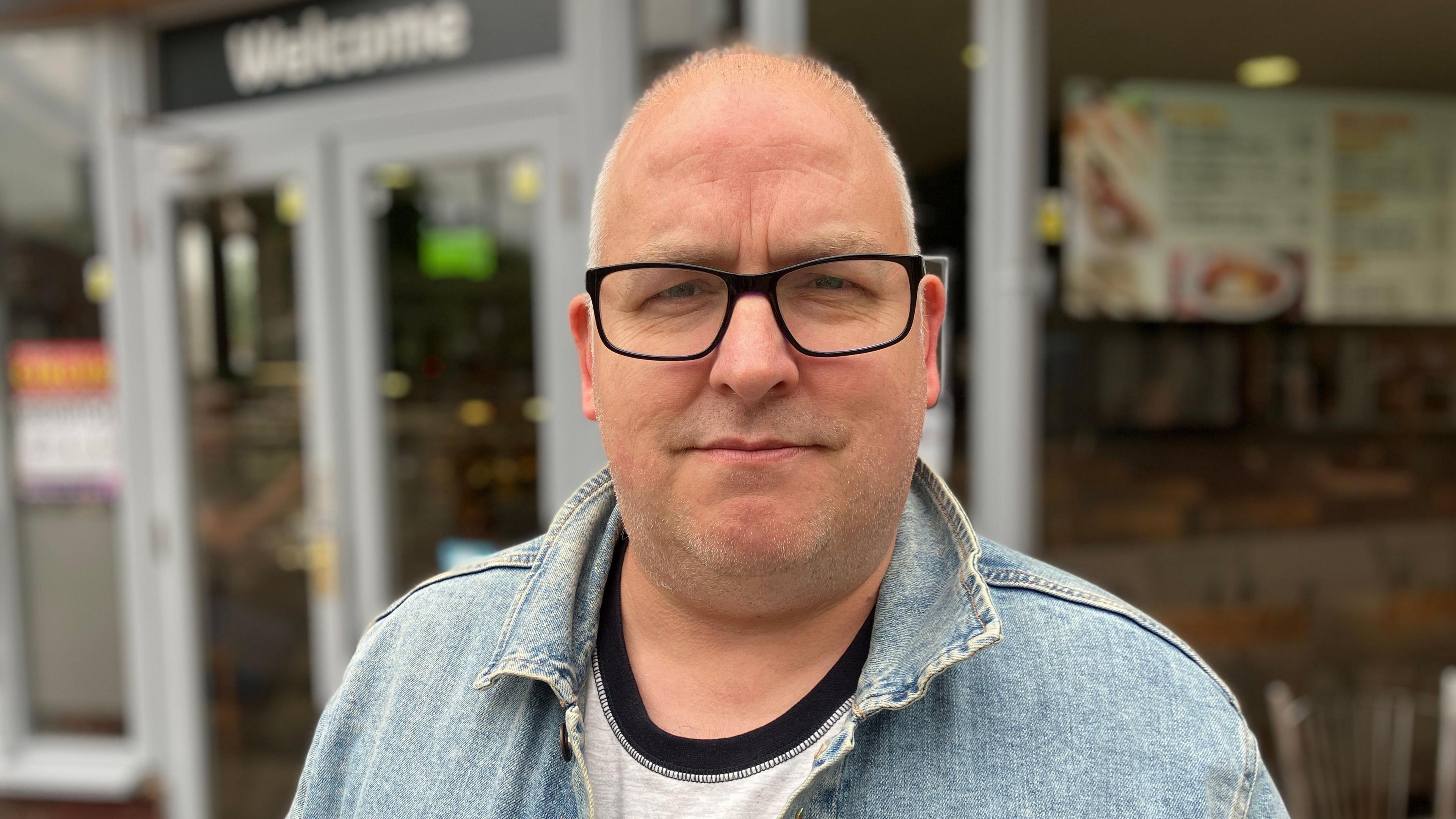 Redditch council leader Joe Baker stands outside a cafe in the town centre