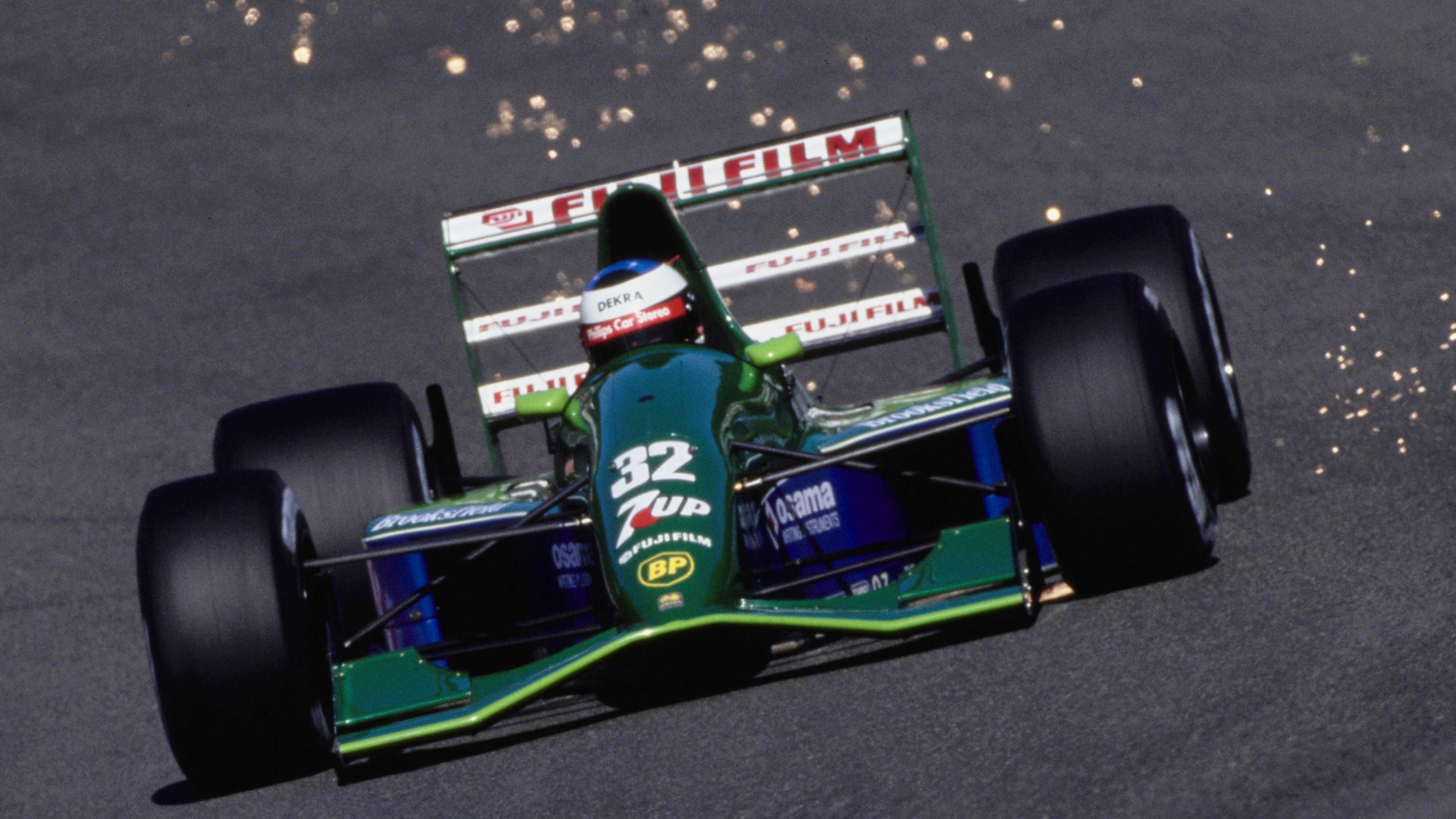 Spars fly from the back of the Jordan as Michael Schumacher drives it in practice for the 1991 Belgian Grand Prix