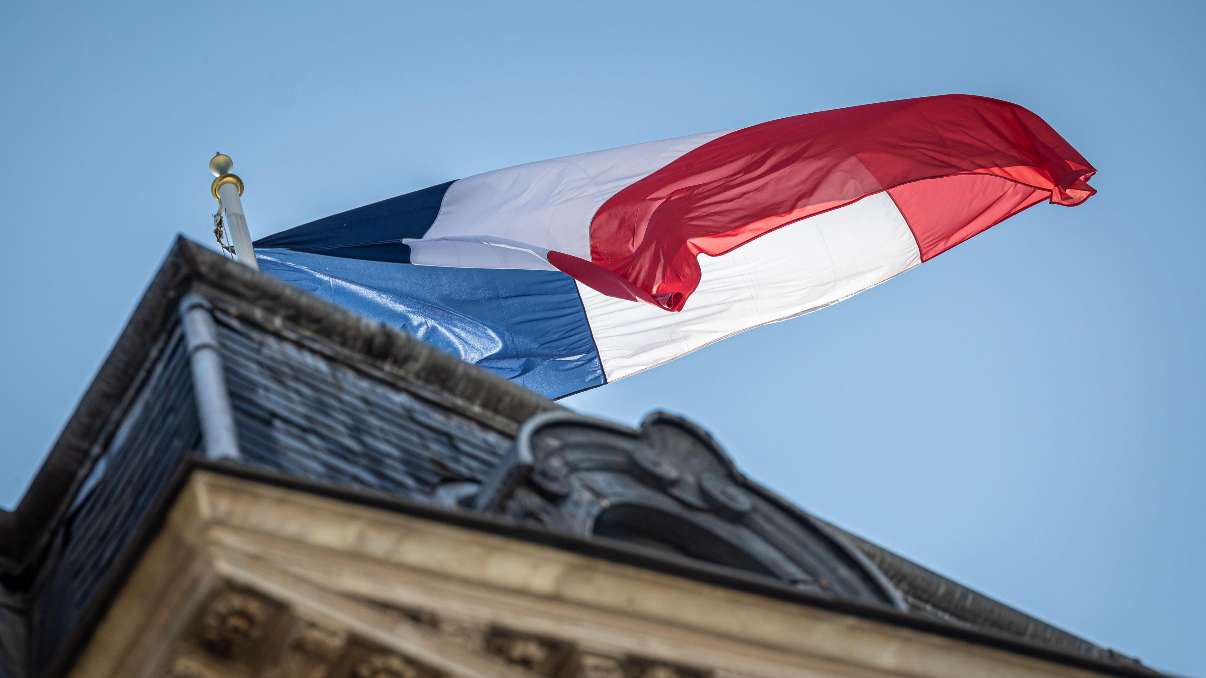 A French flag flying above a building