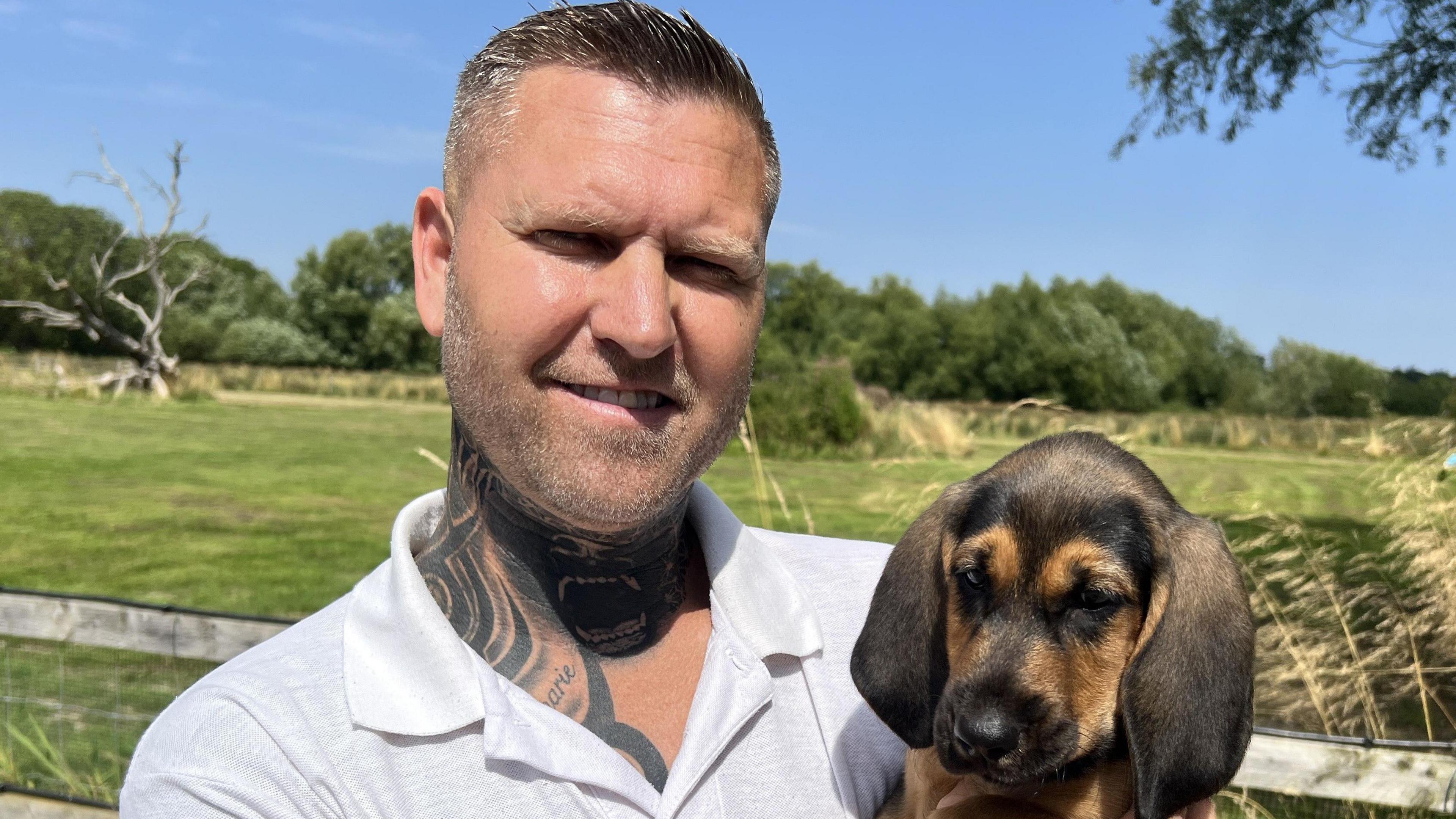 Mr Debenham with one of his bloodhound puppies