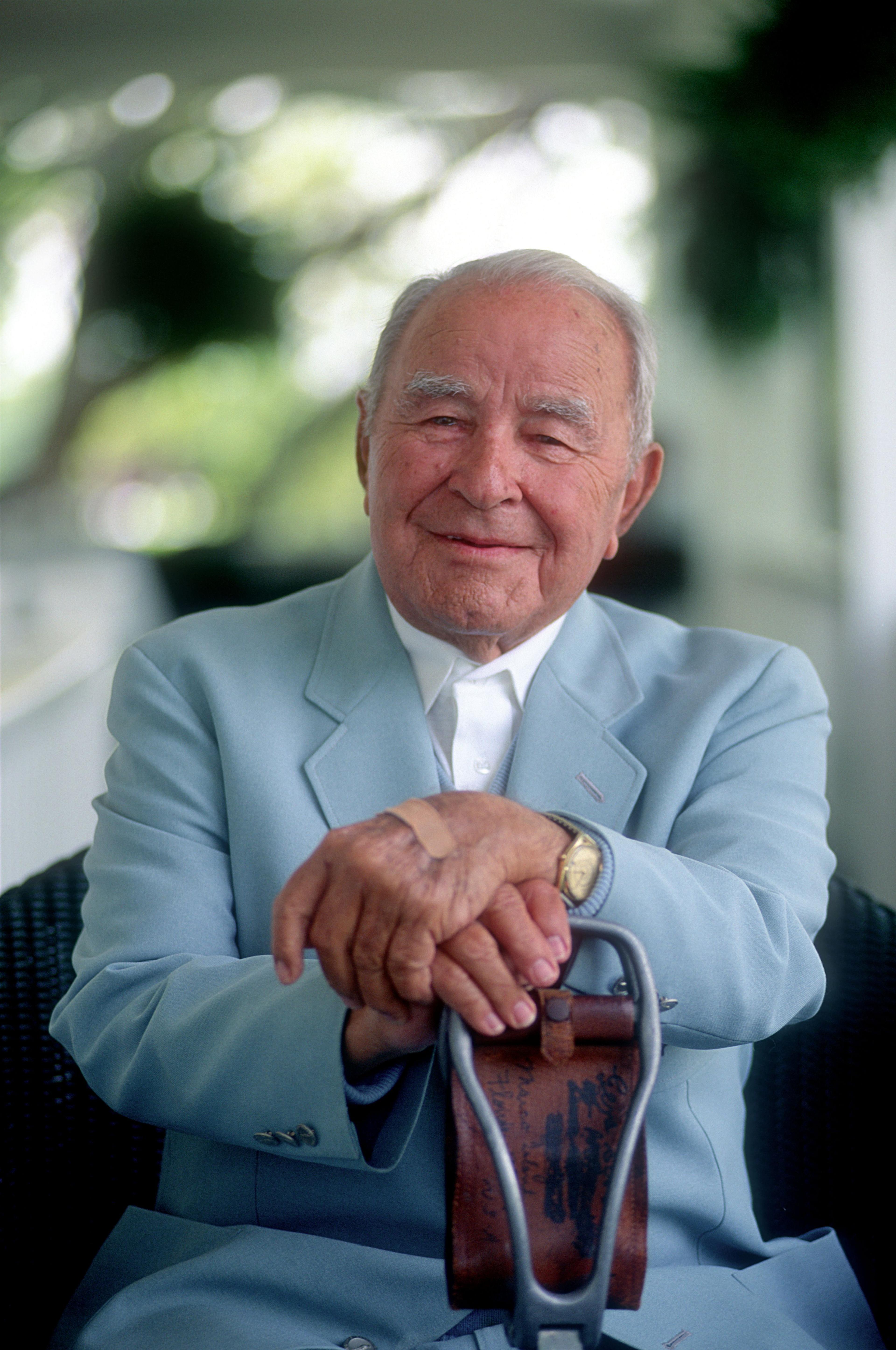 Gene Sarazen sitting on a balcony at the Augusta National clubhouse in 1994