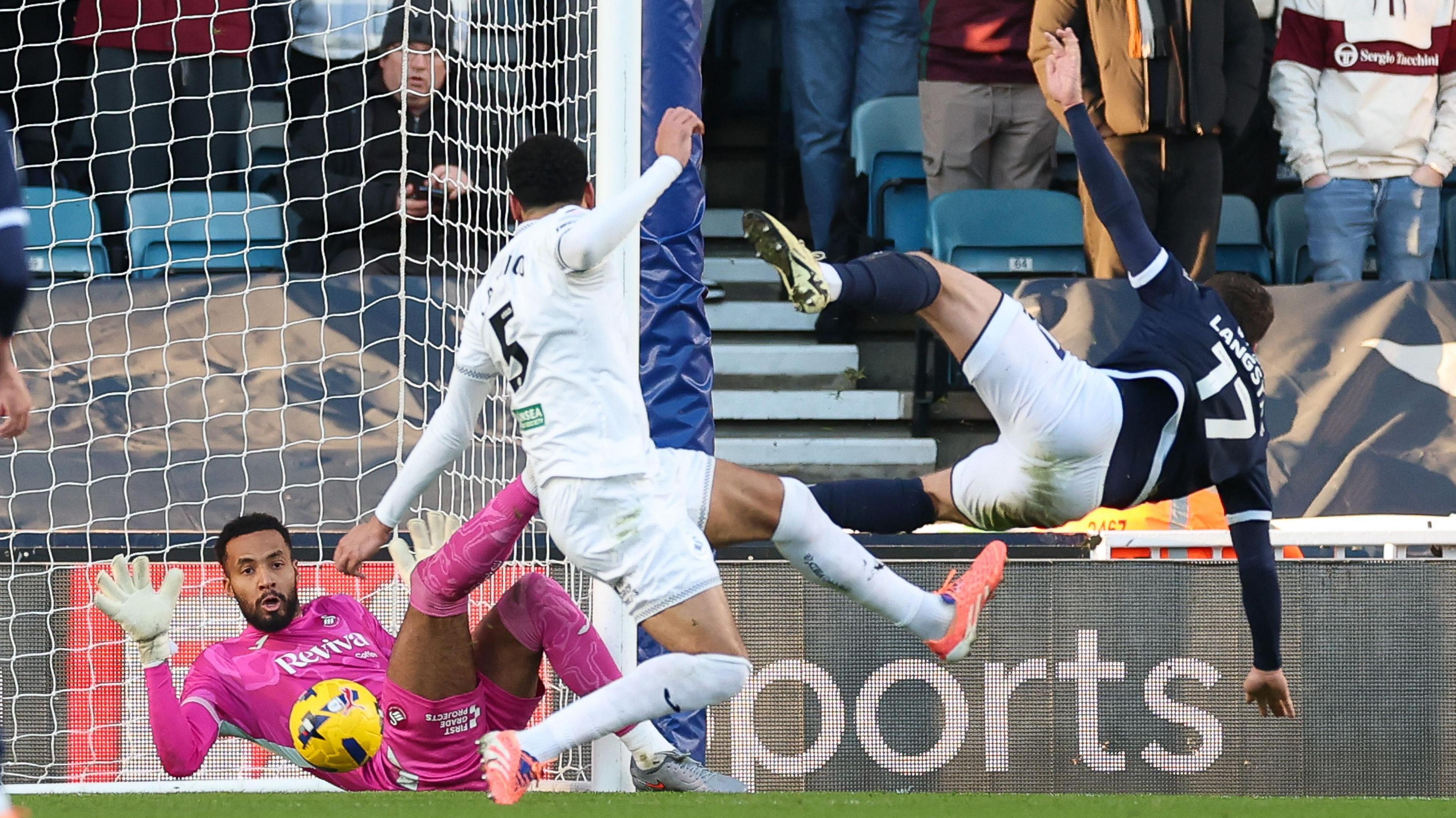 Swansea goalkeeper Lawrence Vigouroux saves from Macaulay Langstaff