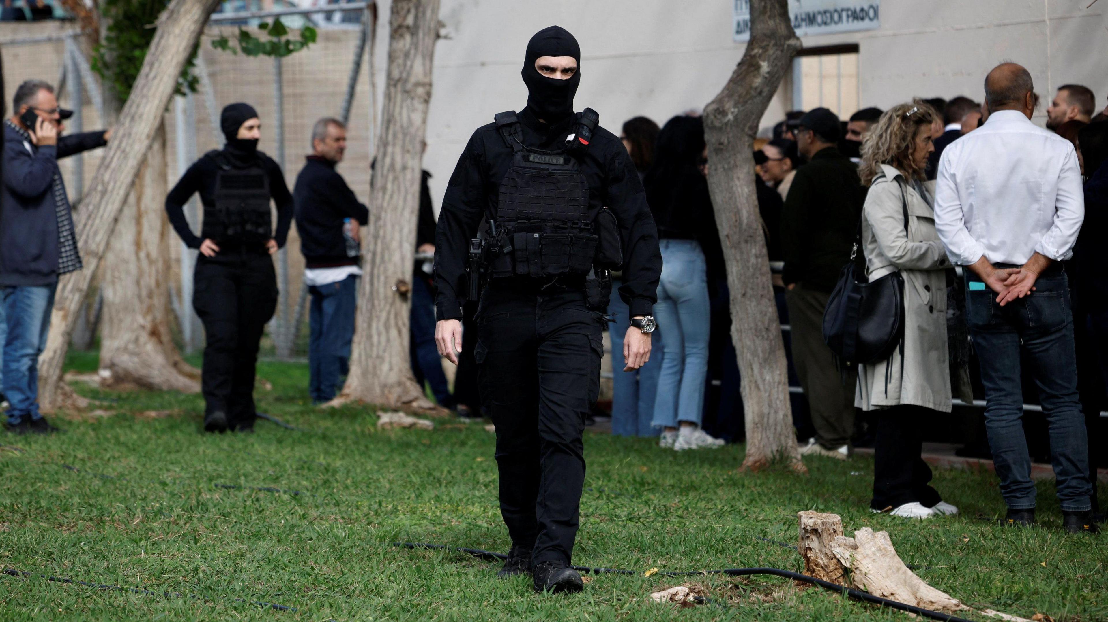 A police officer walks outside Athens' high security Korydallos prison before Olympiacos chairman Marinakis and fans' trial over deadly 2023 sports violence