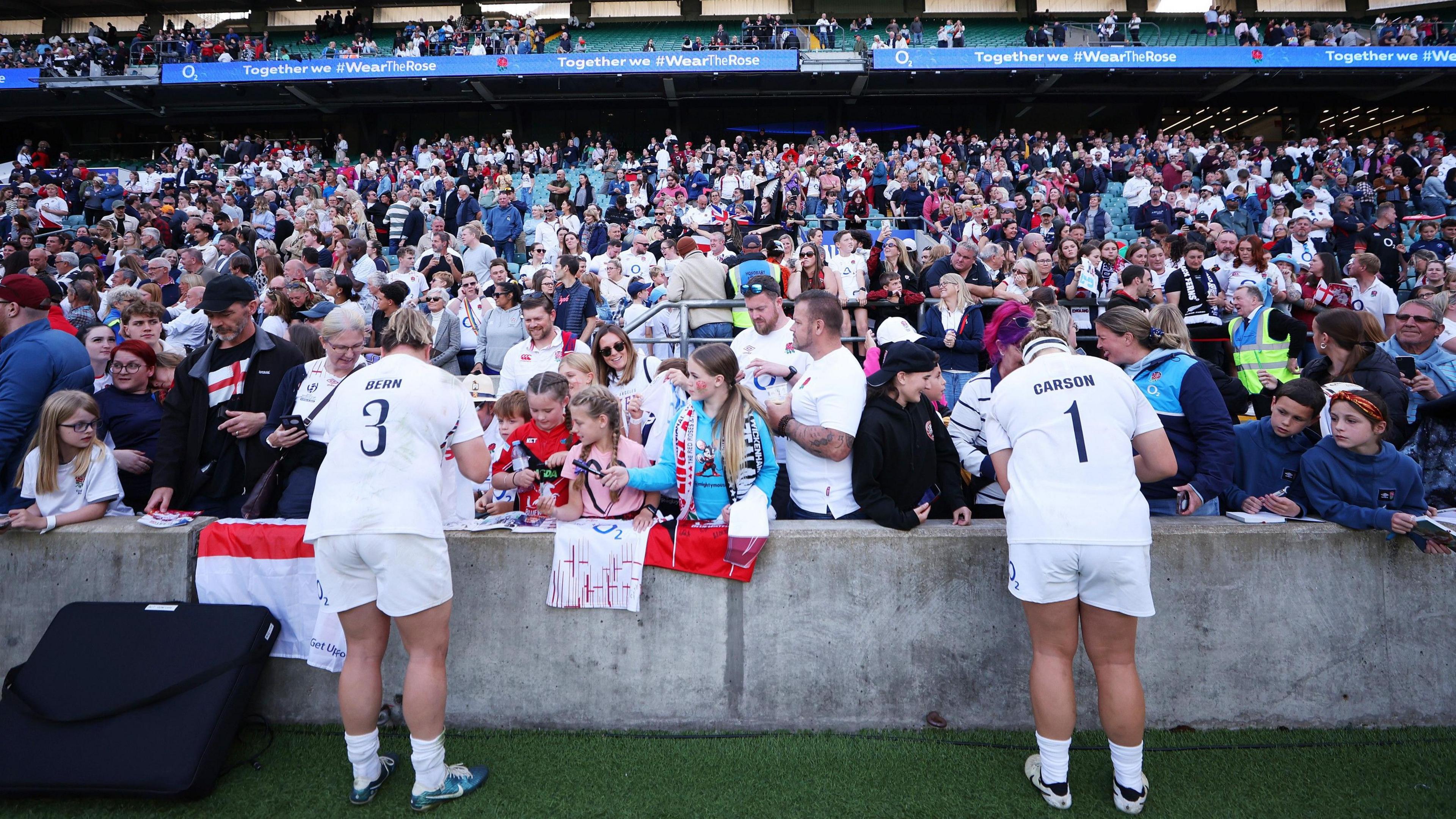 Two Red Roses sign autographs after a match at Twickenham