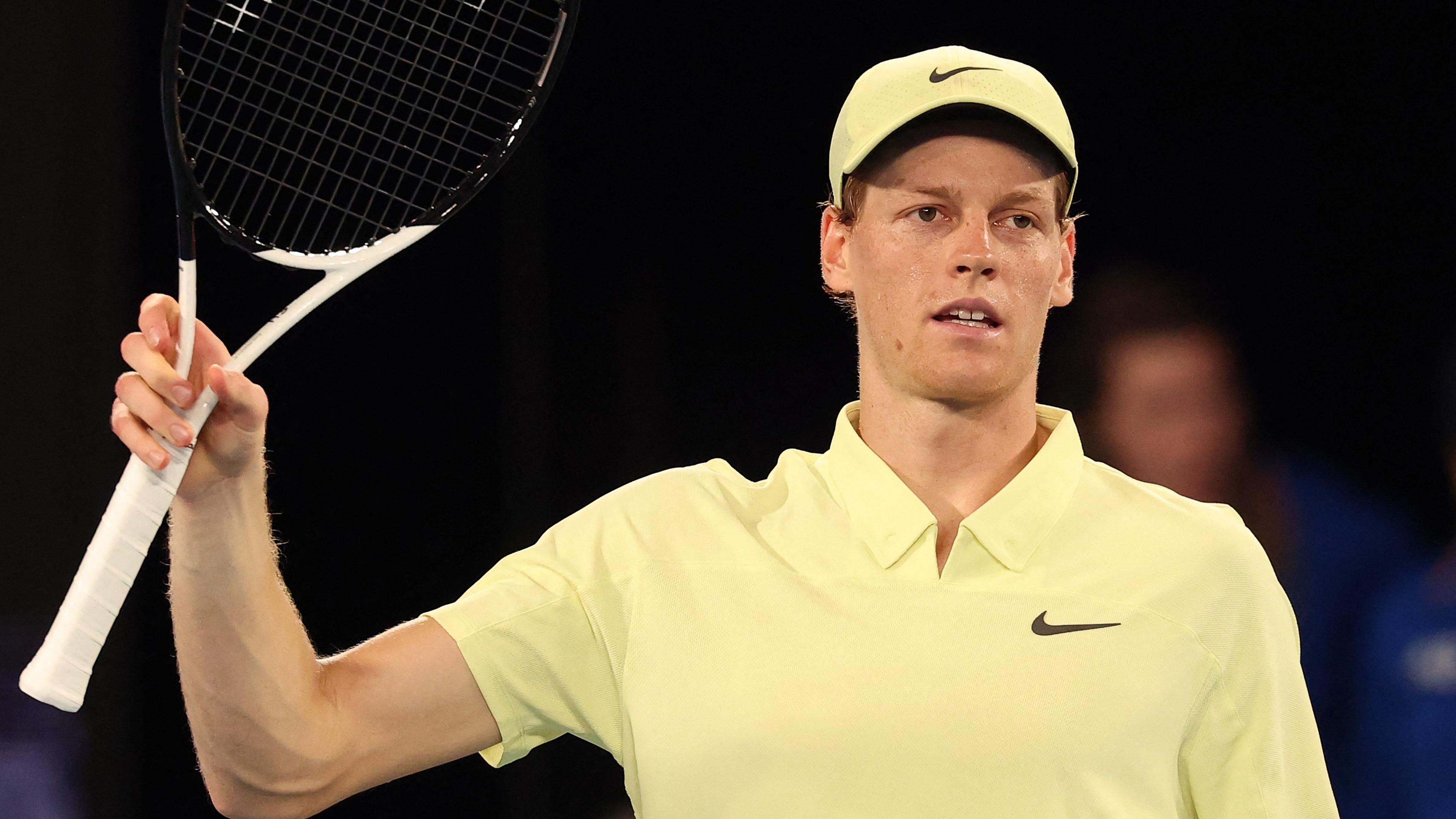 Jannik Sinner waves his racquet to the crowd