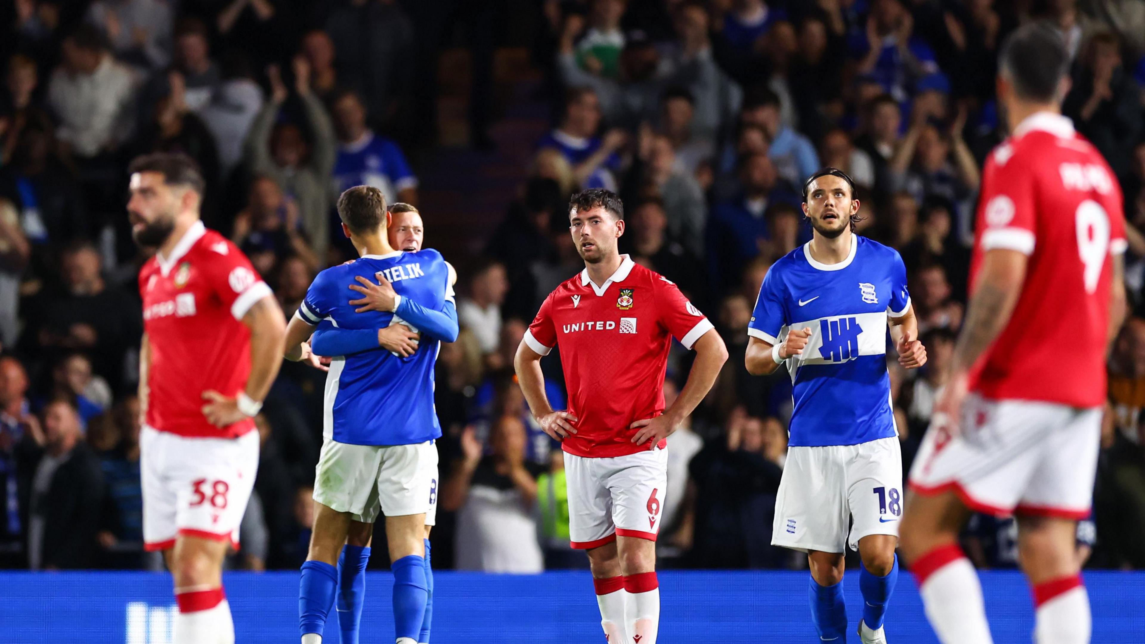 Wrexham players wait for the restart after Birmingham City's Jay Stansfield scores