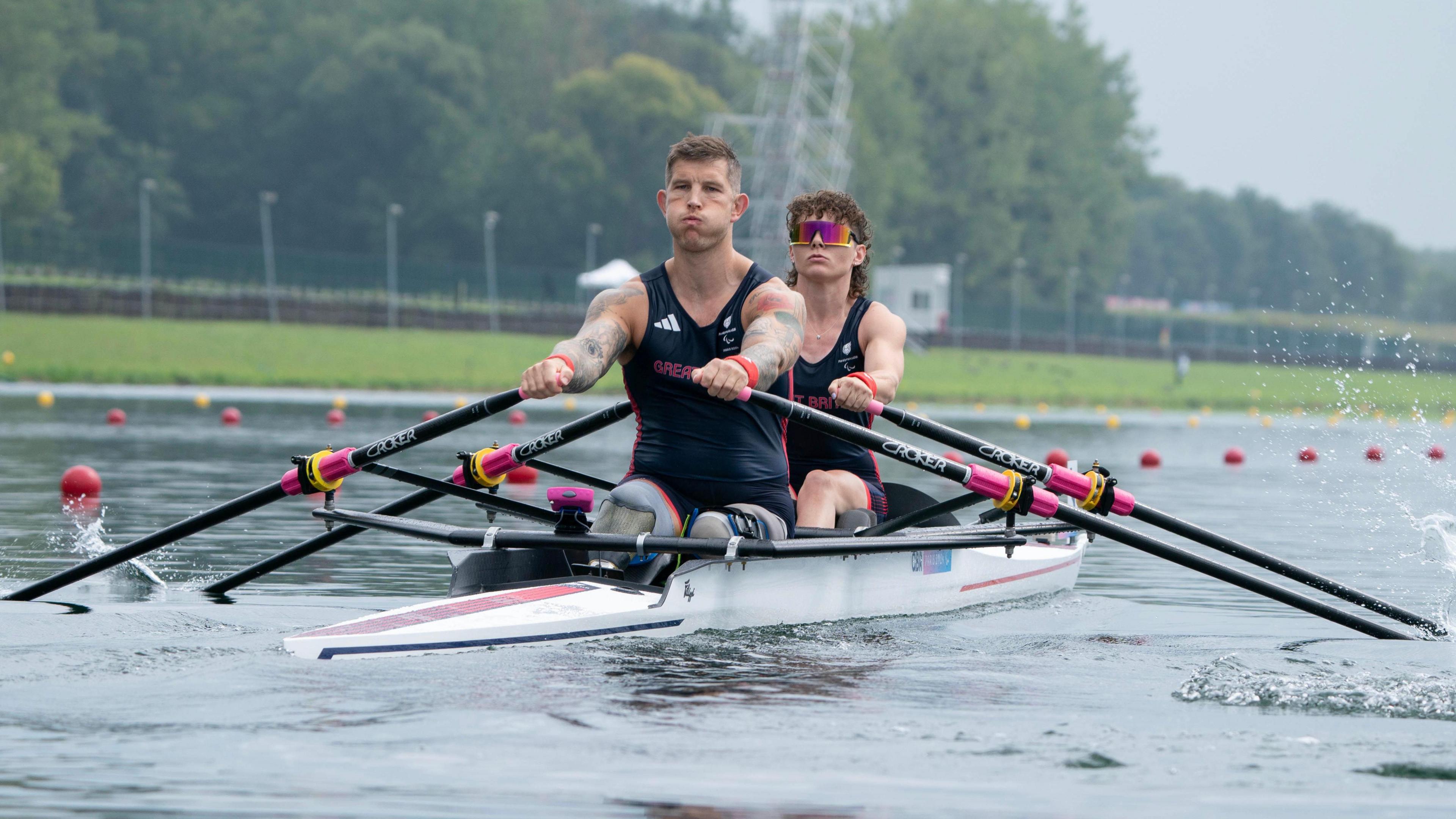 Great Britain's Gregg Stevenson and Lauren Rowles, wearing dark blue vests and shorts, row in their double sculls boat on the Seine in the PR2 Mixed Double Sculls on day two of the Paris 2024 Summer Paralympic Games