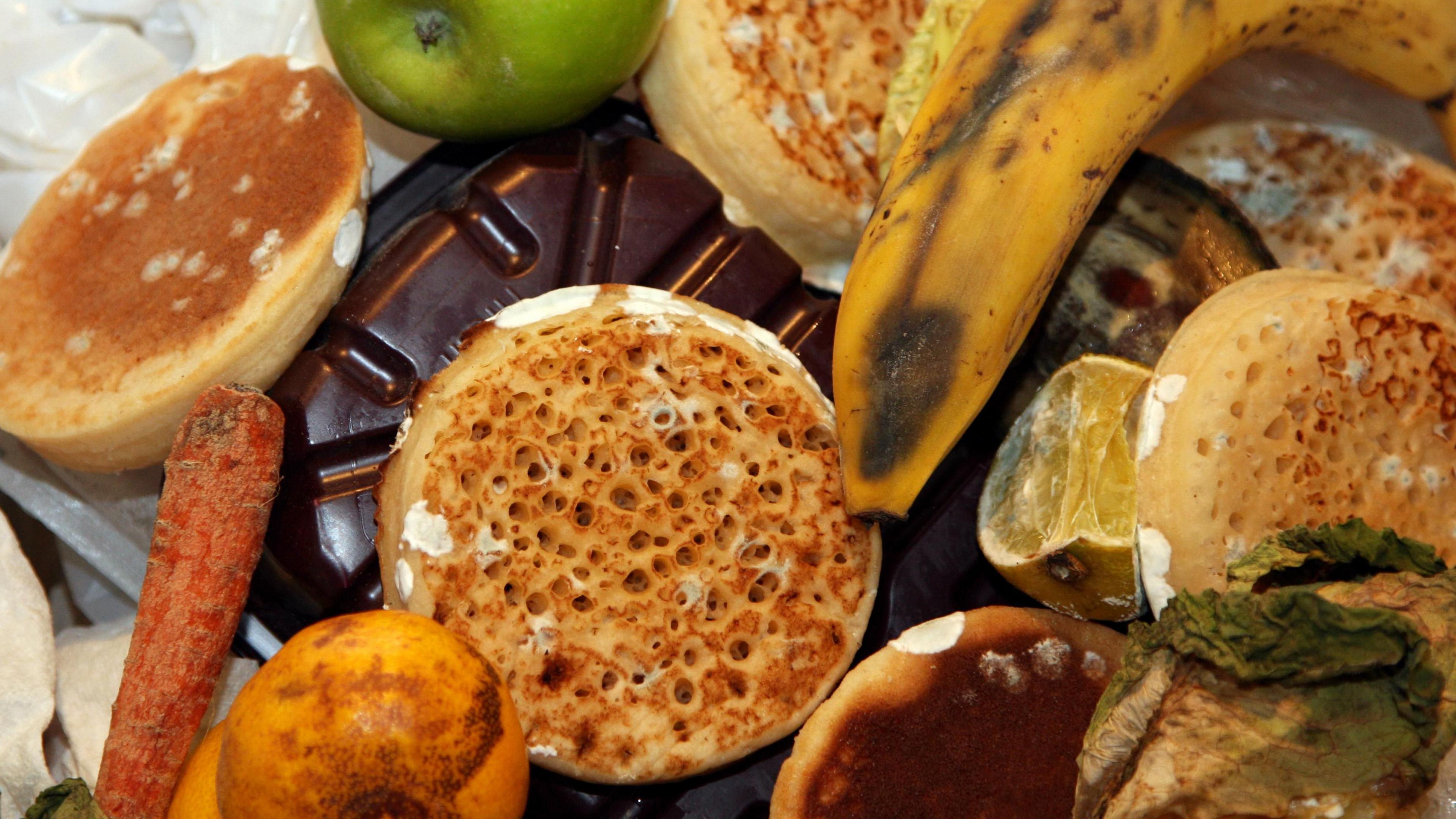 Waste food inside a bin, with mouldy and rotten items.