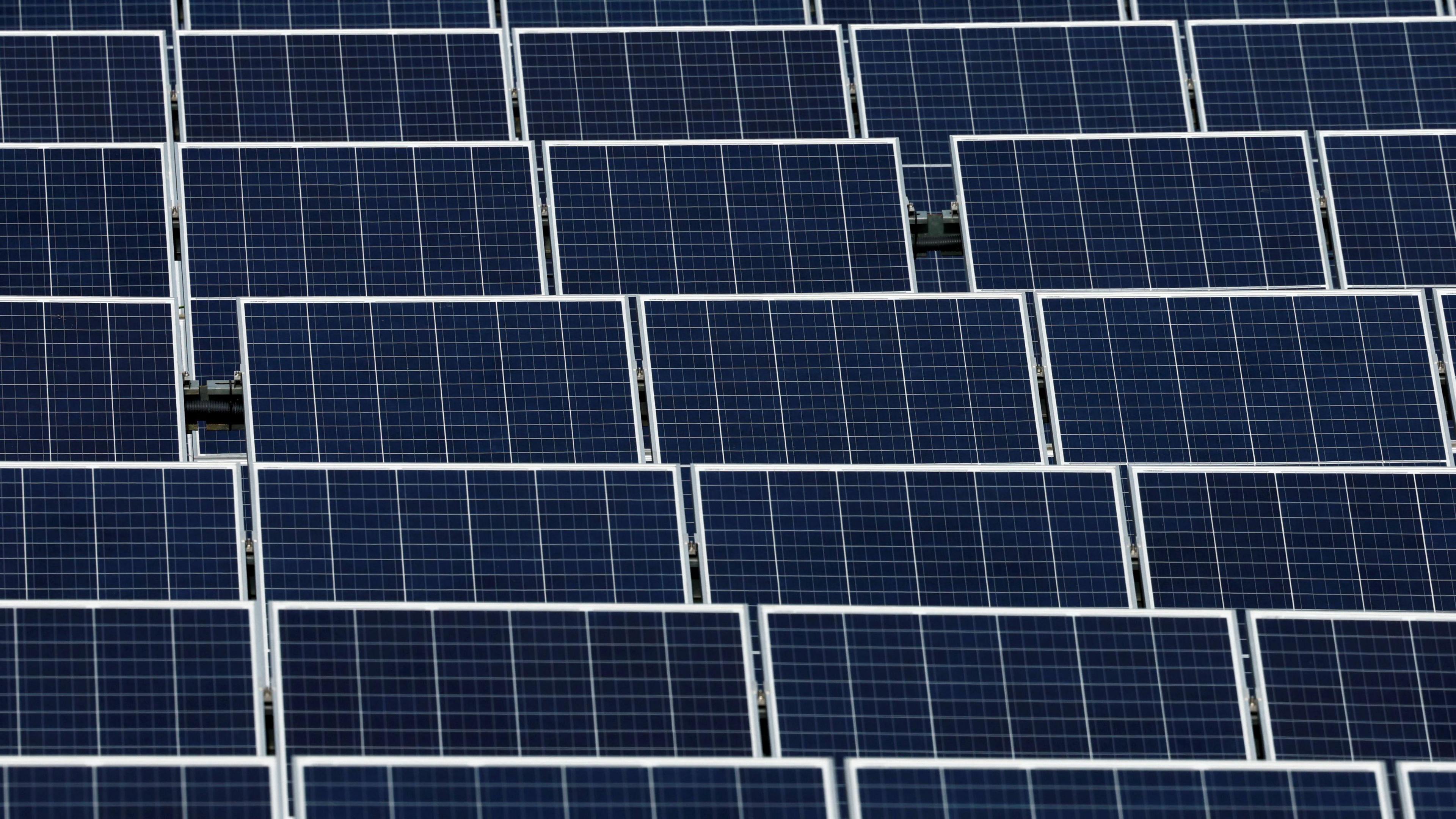 A stock image of solar panels in a solar farm