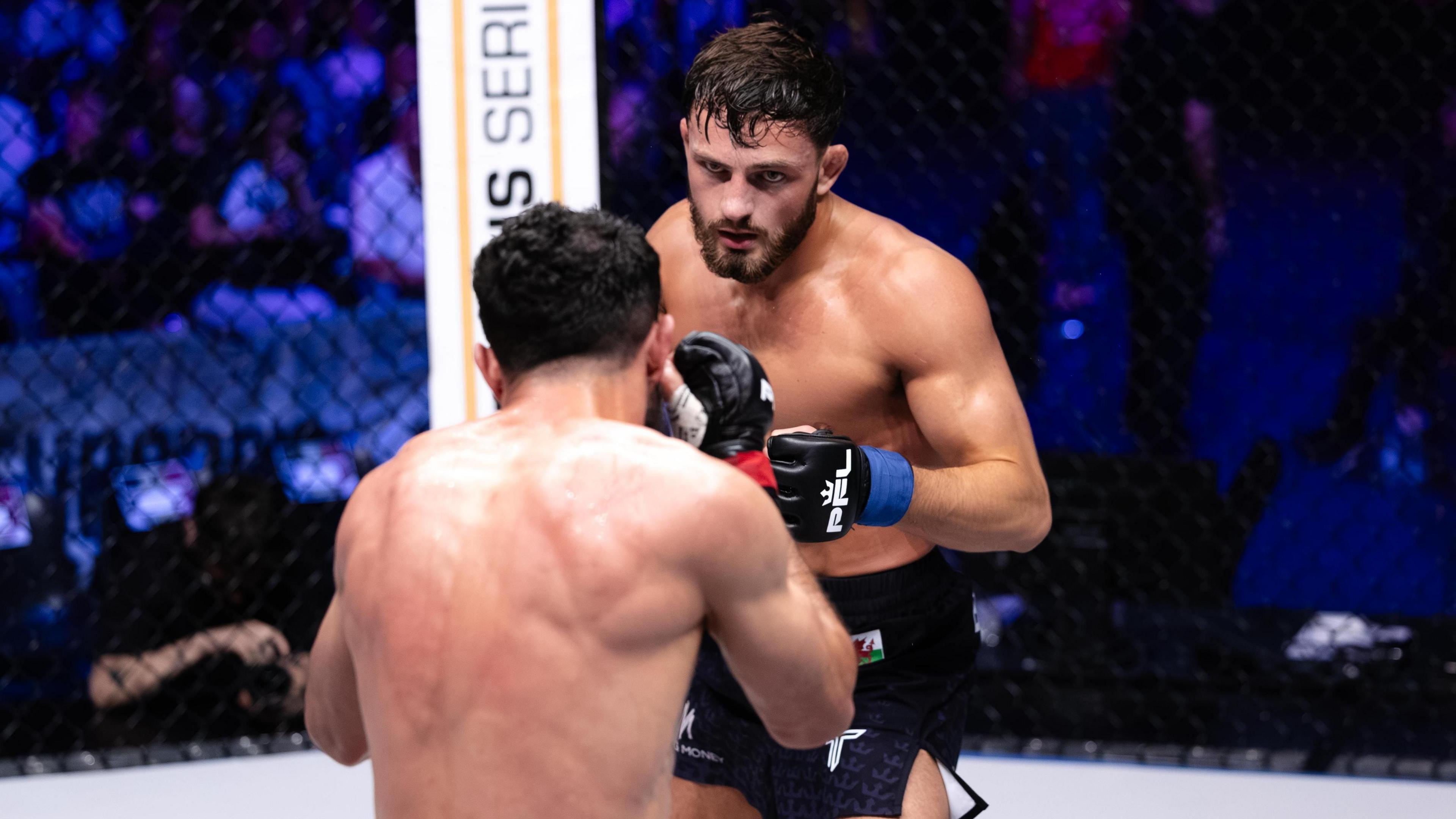 Levi Batchelor facing off against his opponent in the octagon 