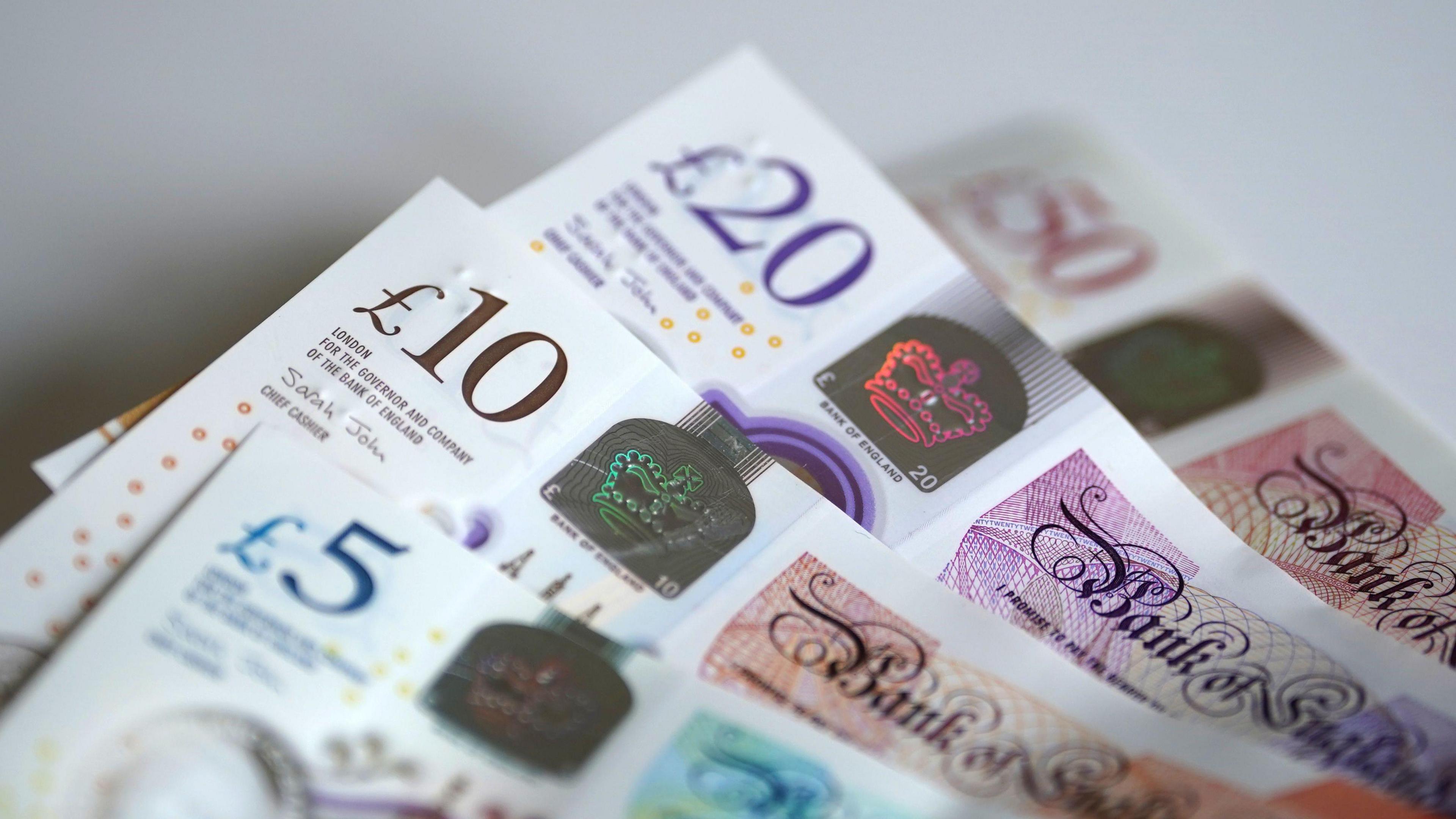 A close up of 5, 10, 20 and 50 pound English notes
