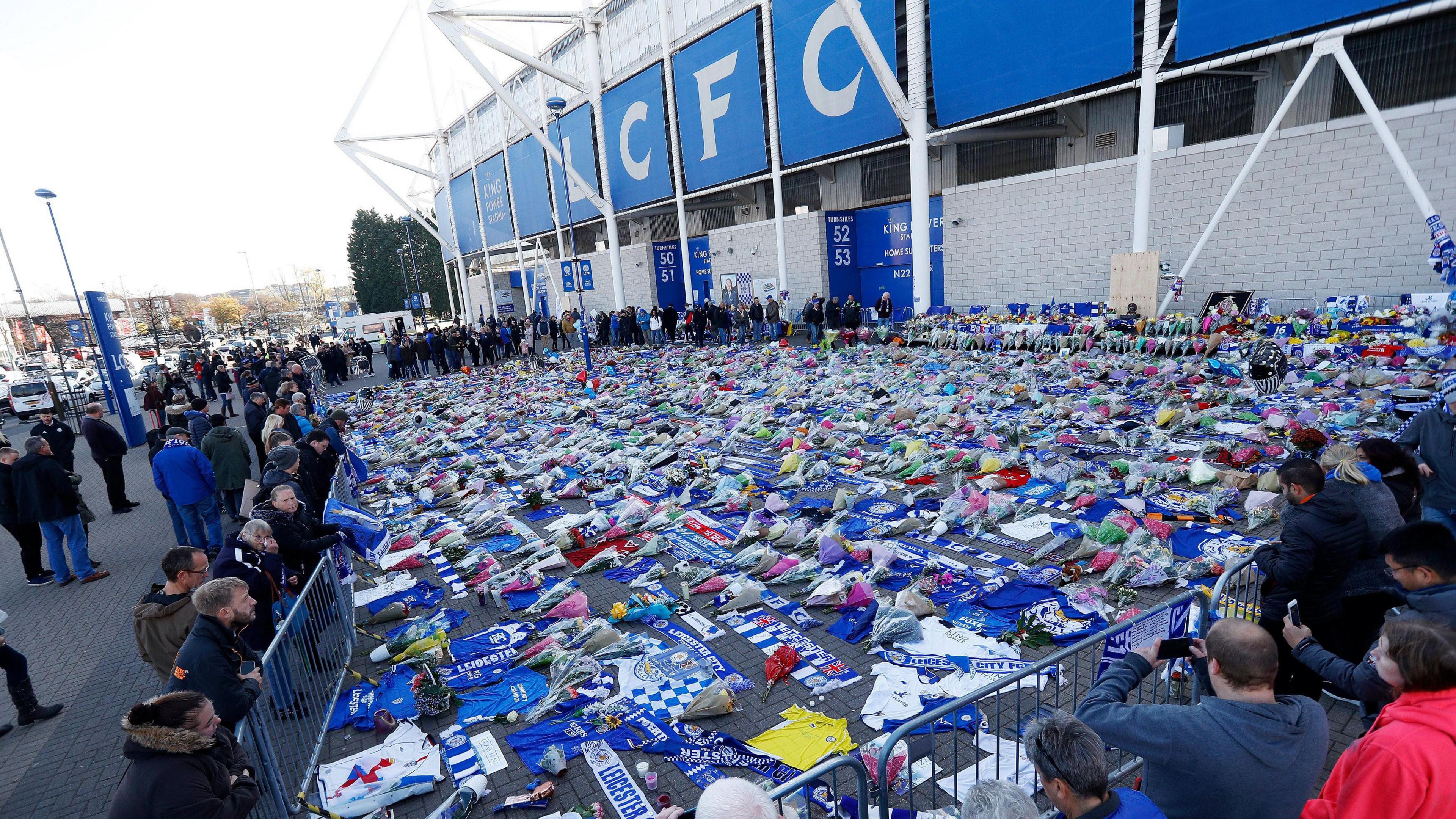 Flowers, balloons and cards left outside the King Power Stadium in 2018