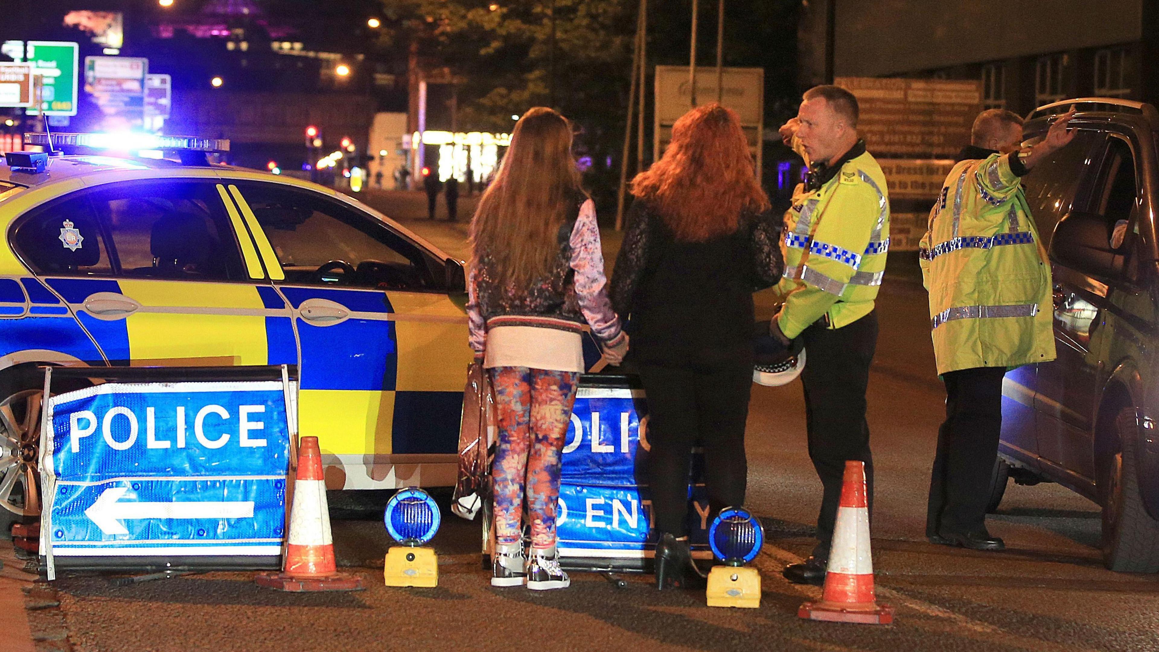 Police speaking to people at the scene of the Manchester Arena attack at the end of a concert by US star Ariana Grande.