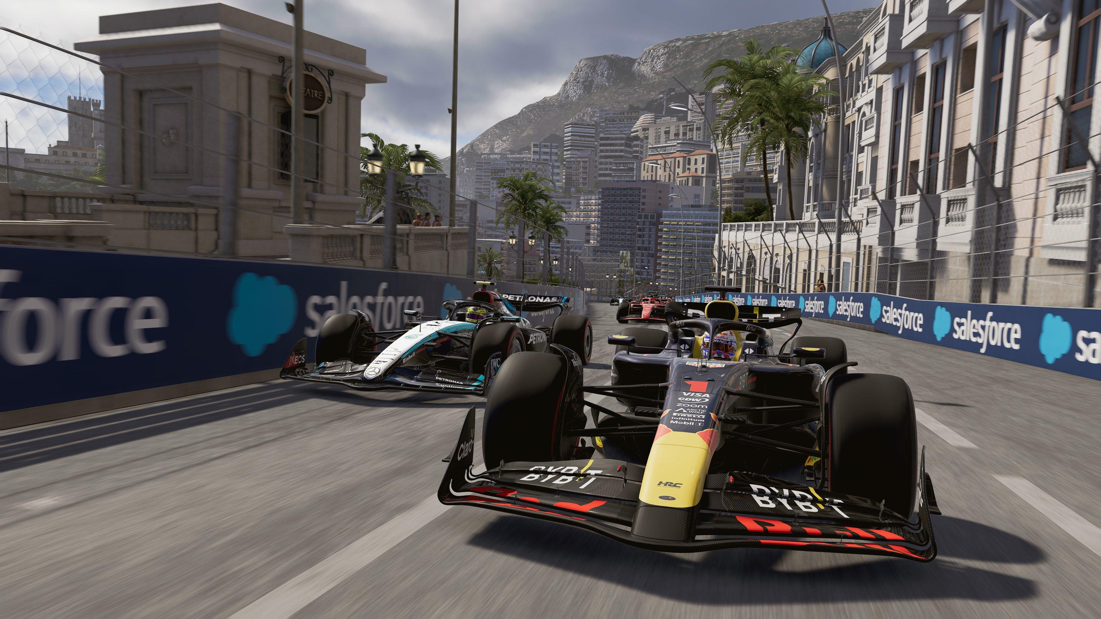 A screenshot from a video game showing two F1 racing cars side by side on a track. Buildings and palm trees can be seen in the background