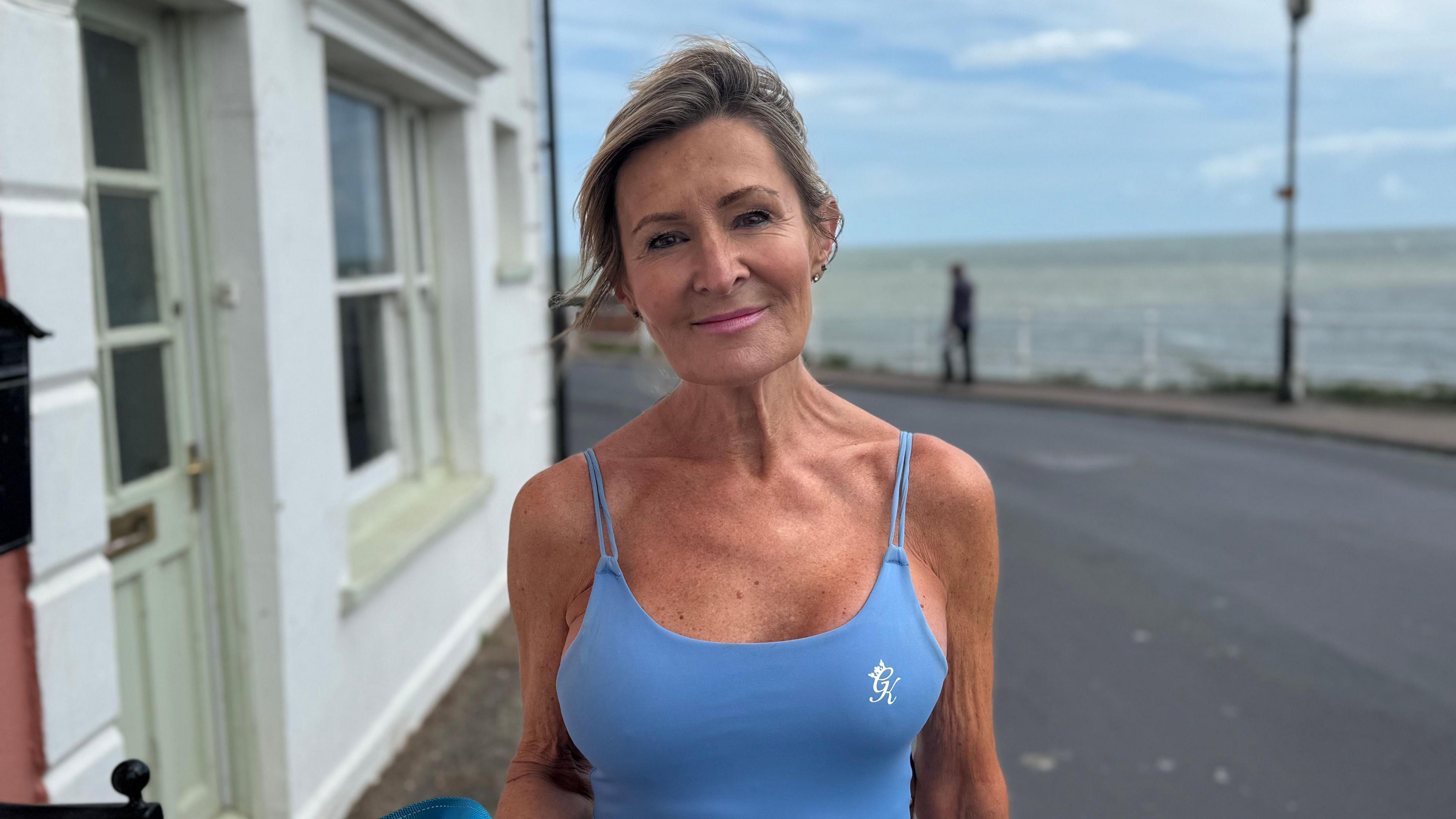 A head and shoulders image of Deborah Carrington. She is wearing a light blue coloured sports vet and looking directly into the camera.