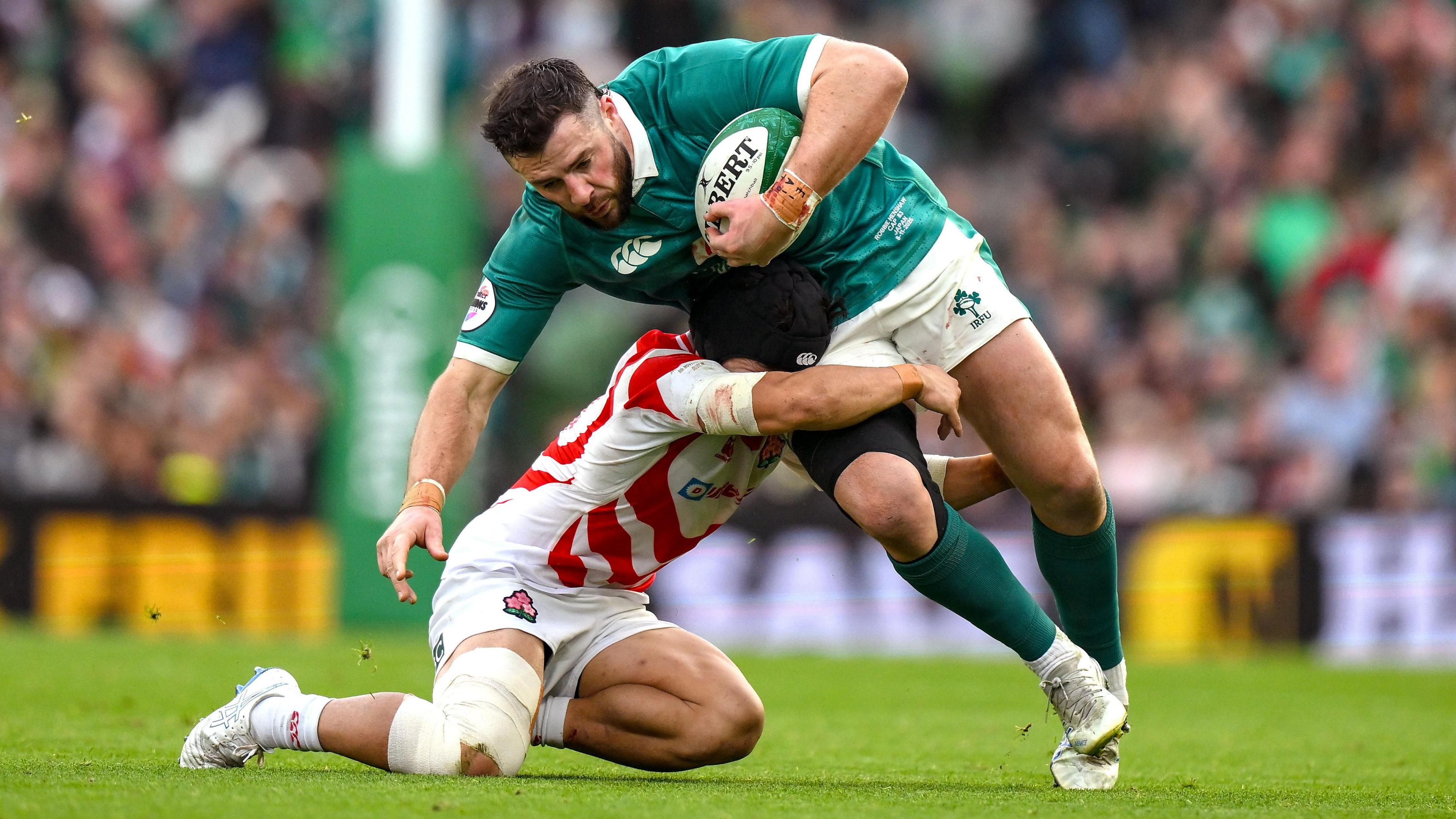 Ireland centre Robbie Henshaw is tackled