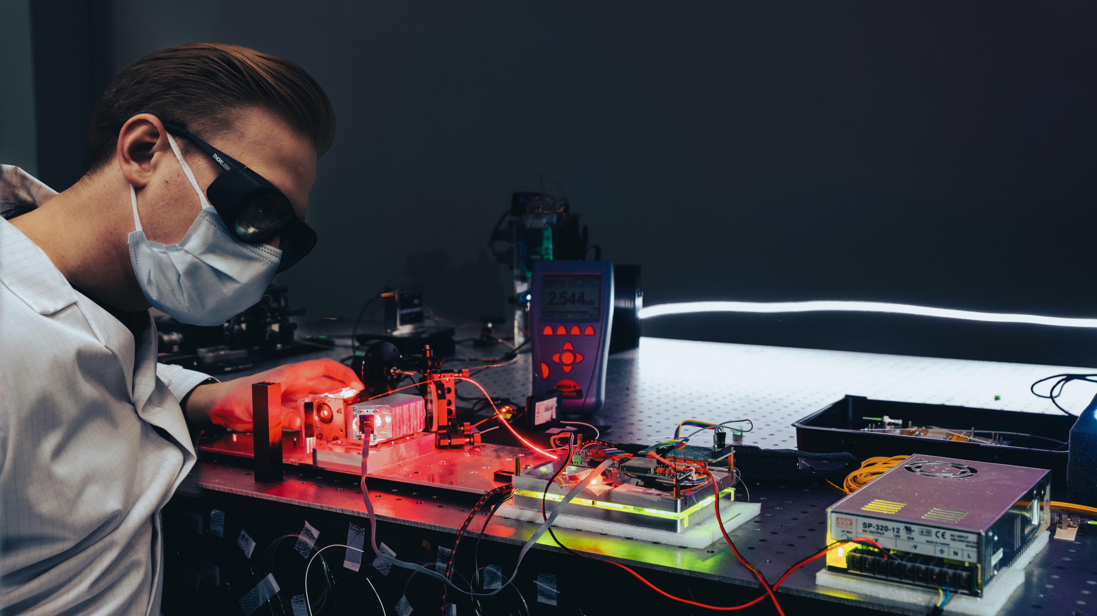 A technician works with lasers at Astrolight's lab