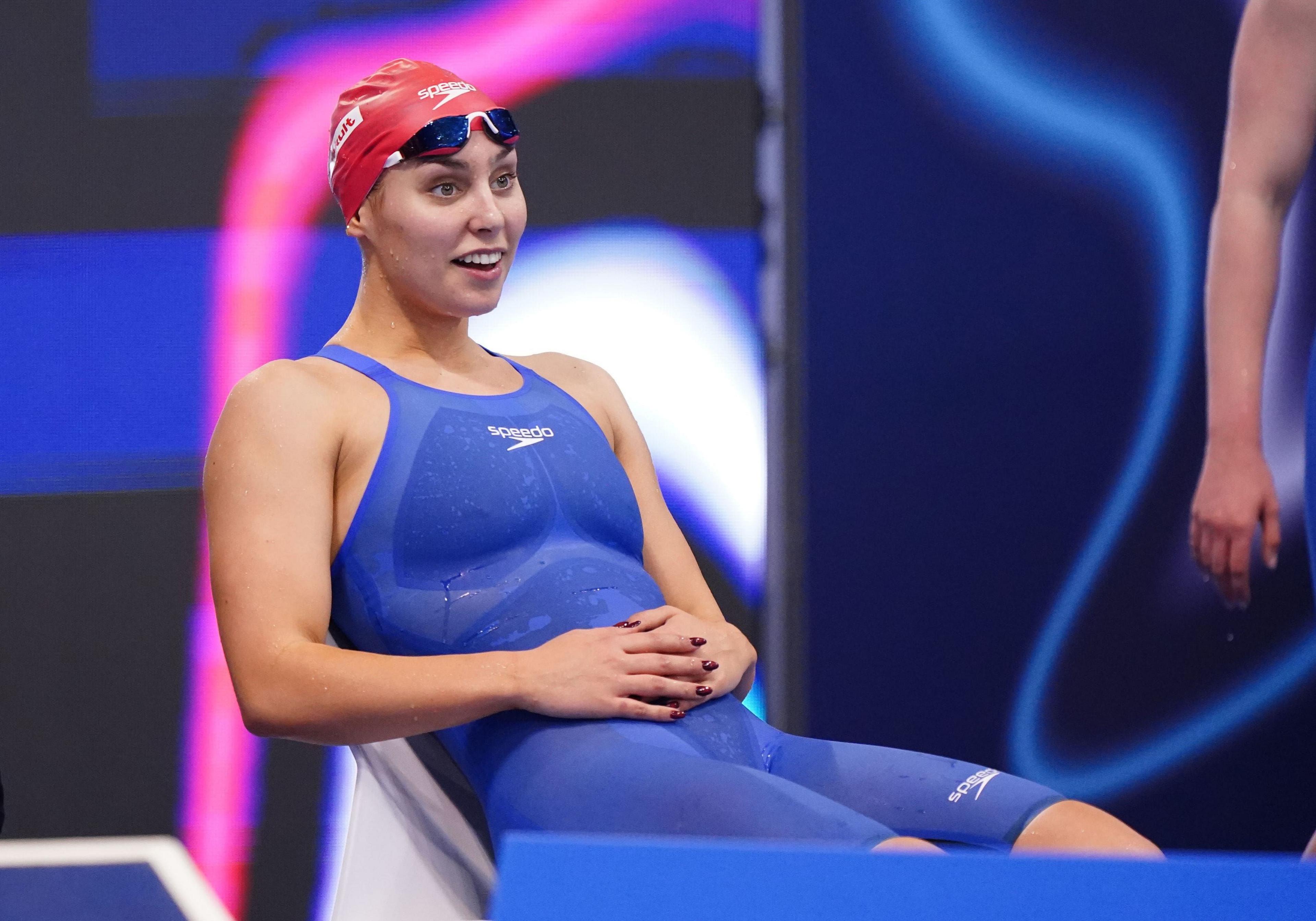 Swimmer Freya Colbert looks happy waiting poolside