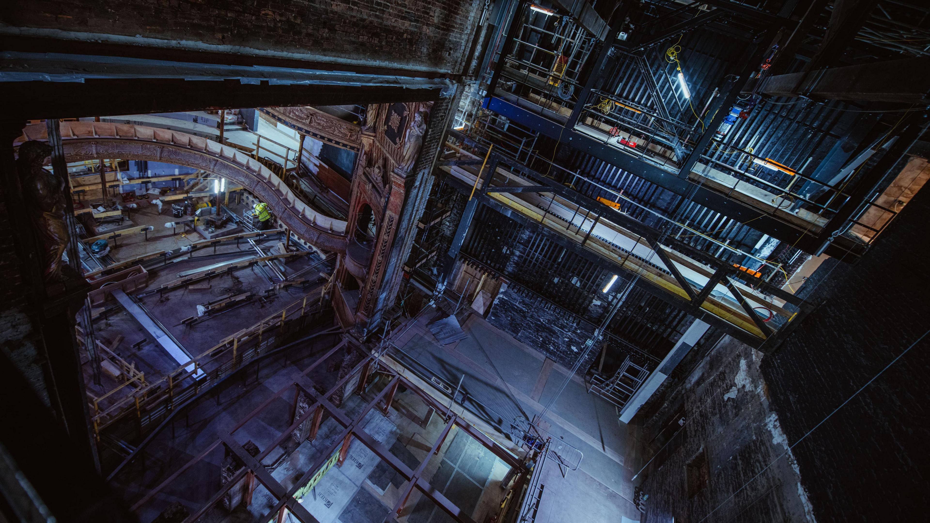 A scene inside the Citizens Theatre as it undergoes redevelopment. Several parts of the floor are missing and there is scaffolding on many of the upper levels.