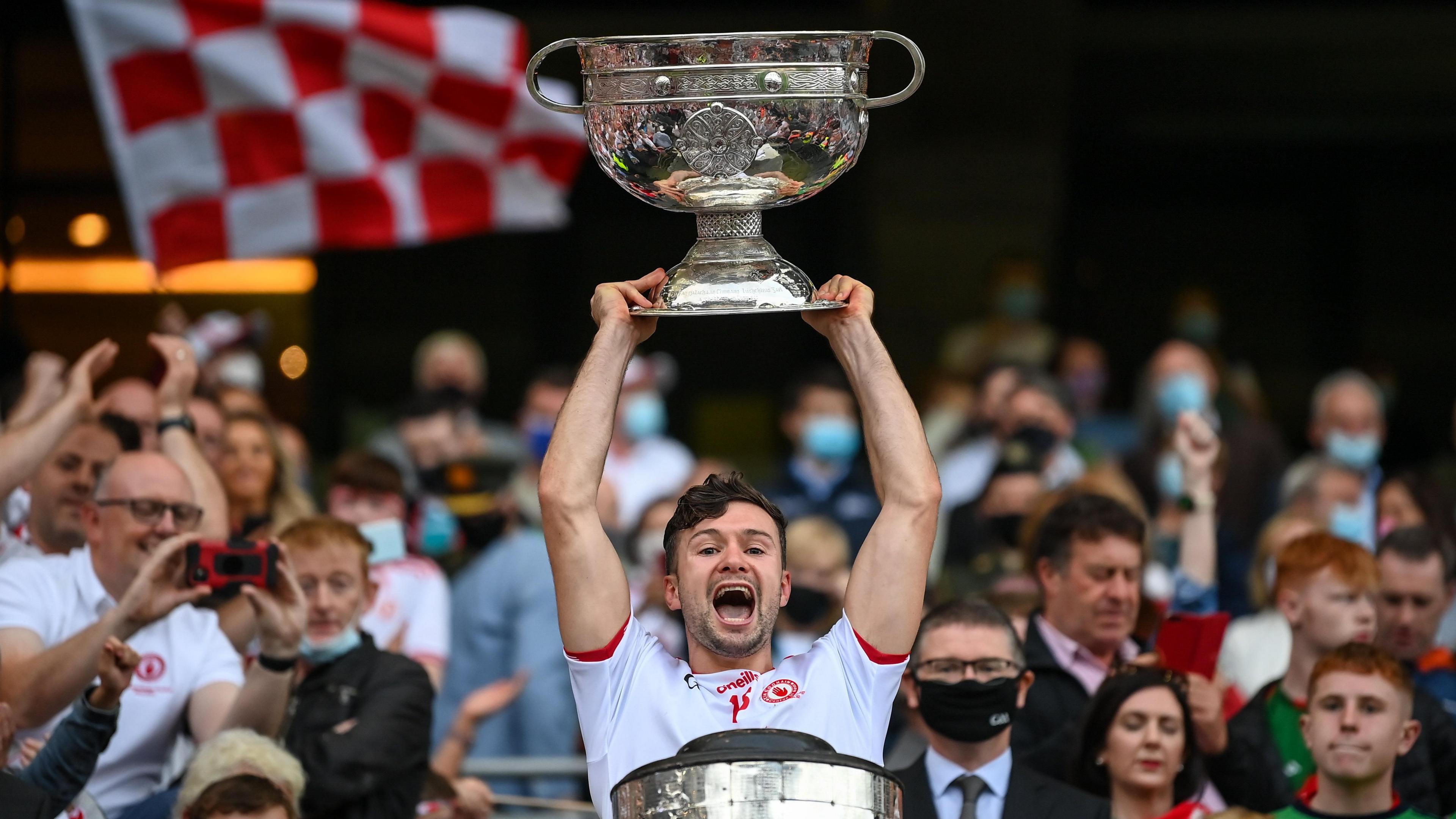 Conor McKenna holds the Sam Maguire Cup aloft after Tyrone's victory over Mayo in September 2021