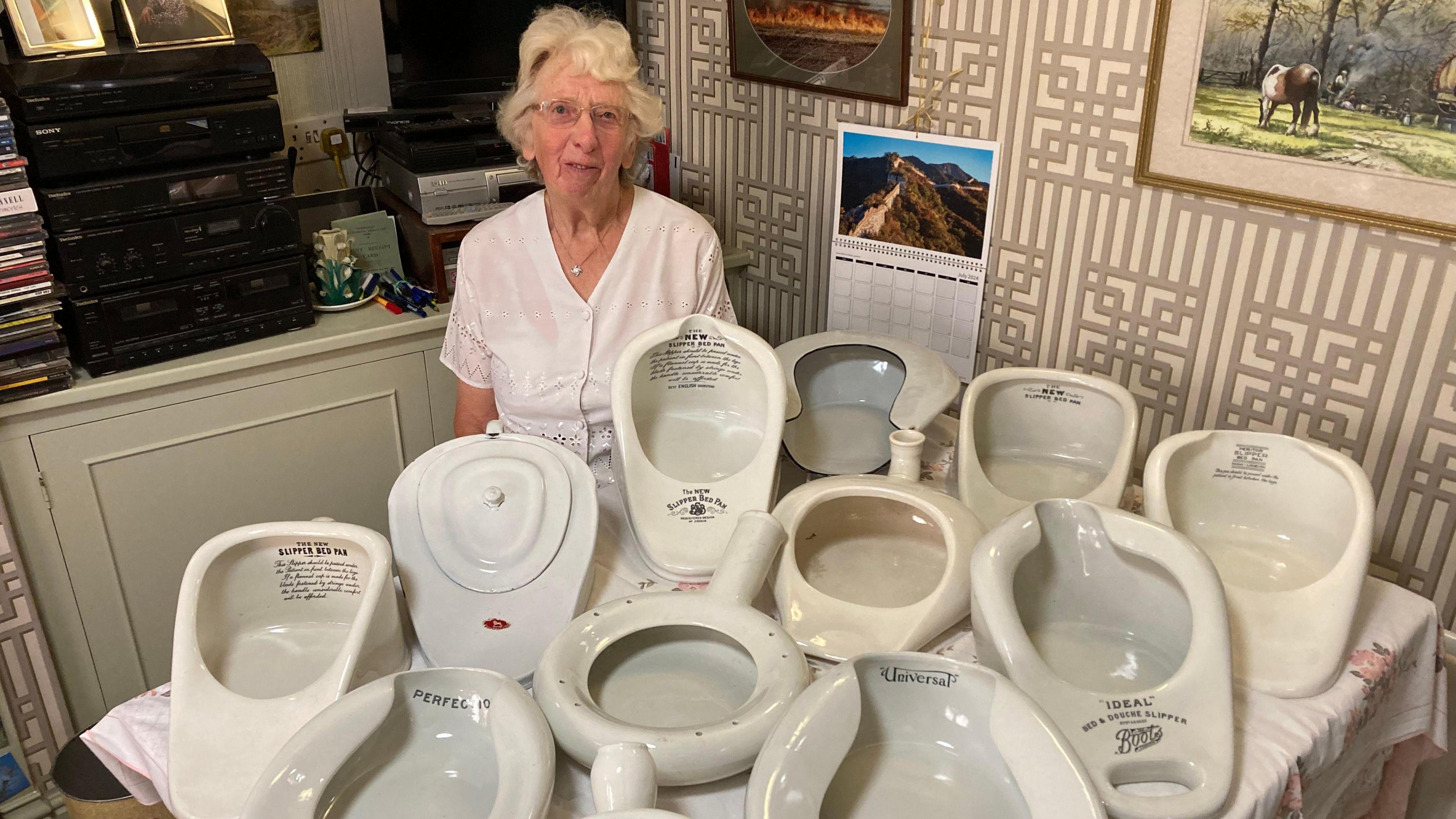 Mary Jacobs with some of her collection of bedpans