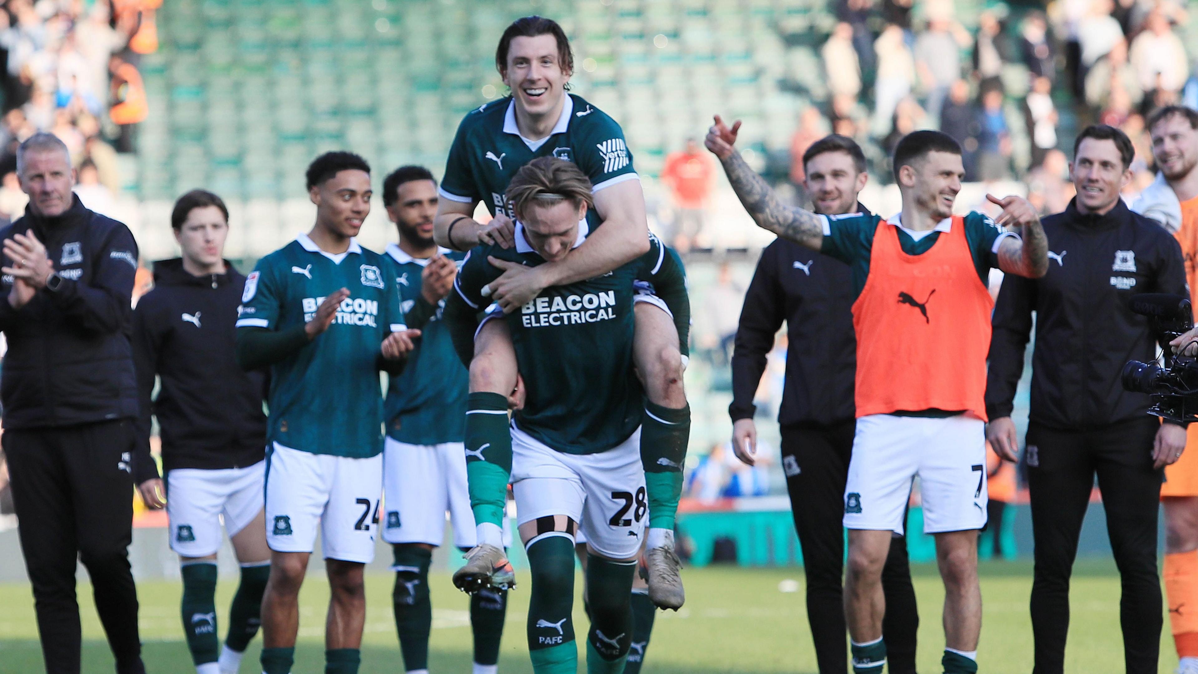 Plymouth Argyle players celebrate beating Huddersfield Town
