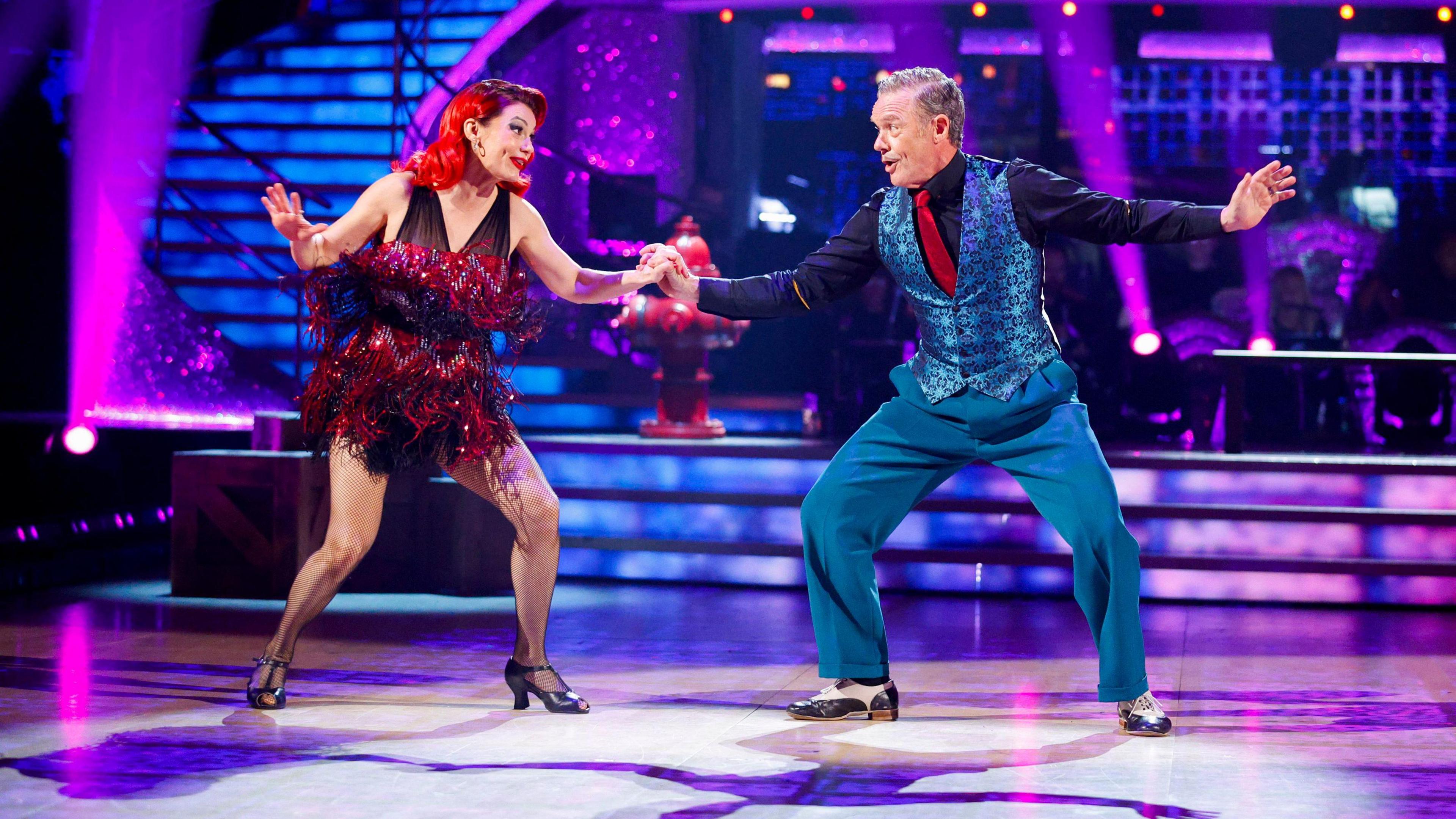 Dianne buswell in a red tassly dress dancing the Charleston with Stefan Dennis in a blue suit