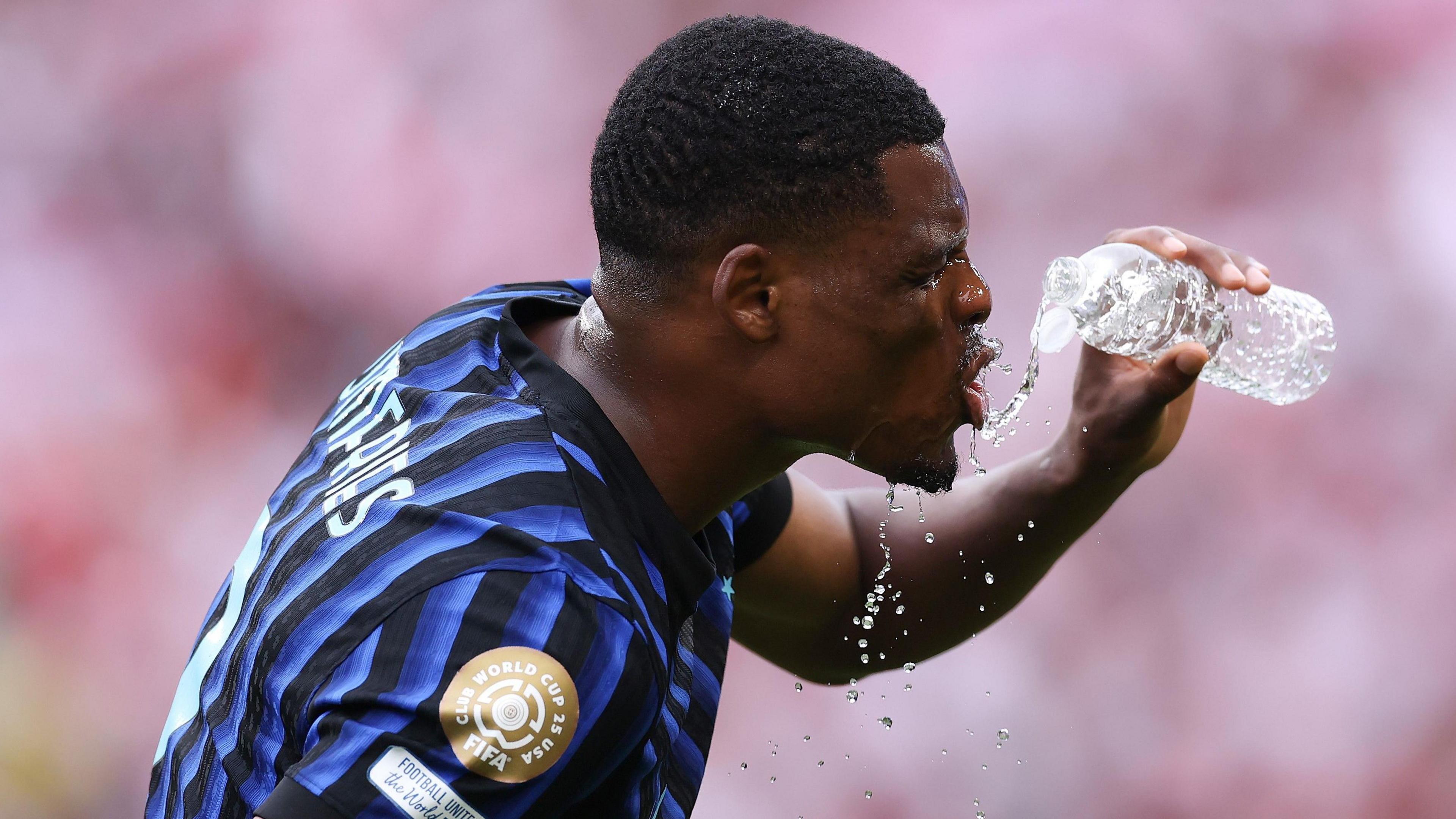Denzel Dumfries drinking water while playing for Inter Milan