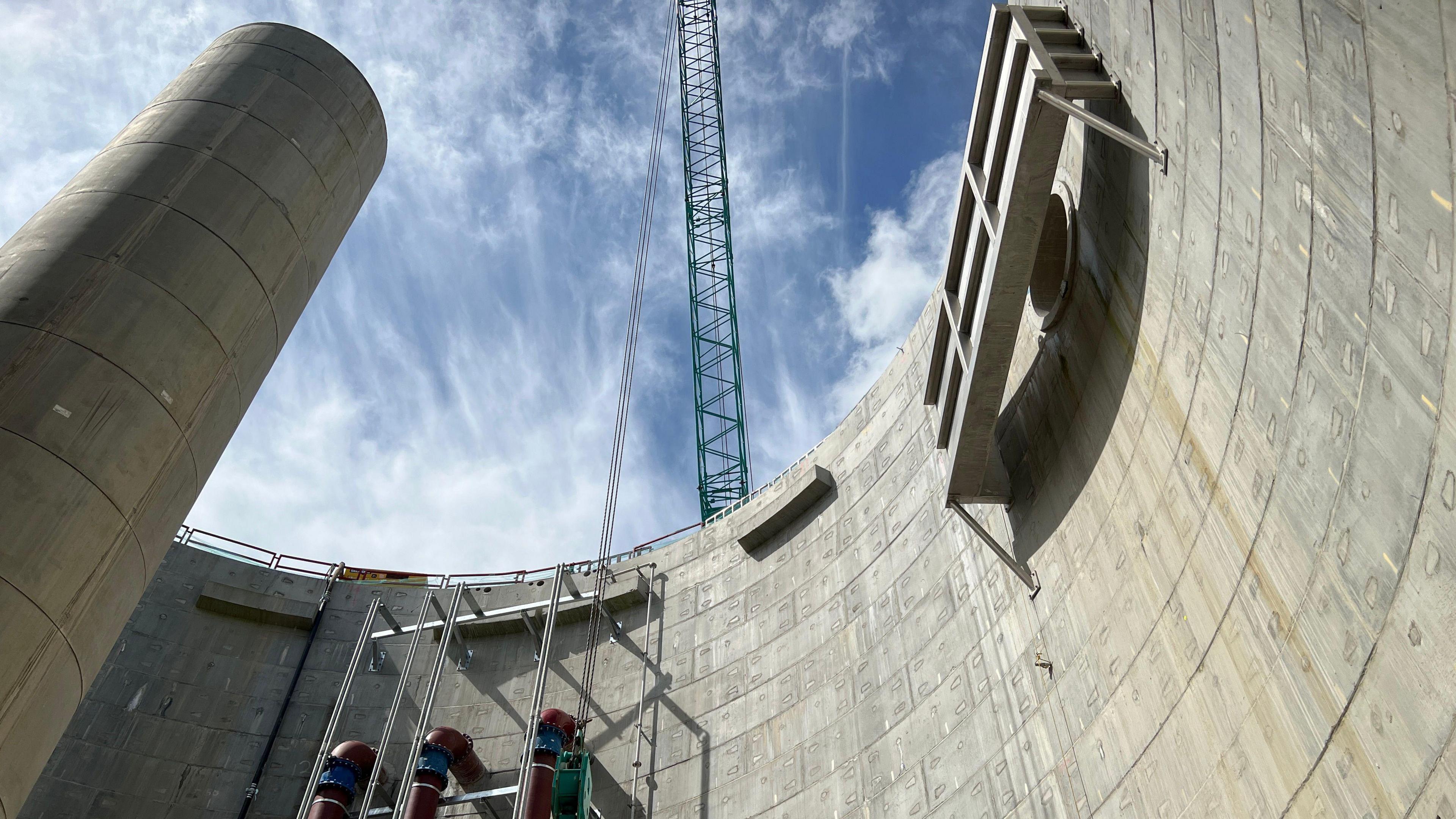 A very large concrete water tank seen from the bottom up 