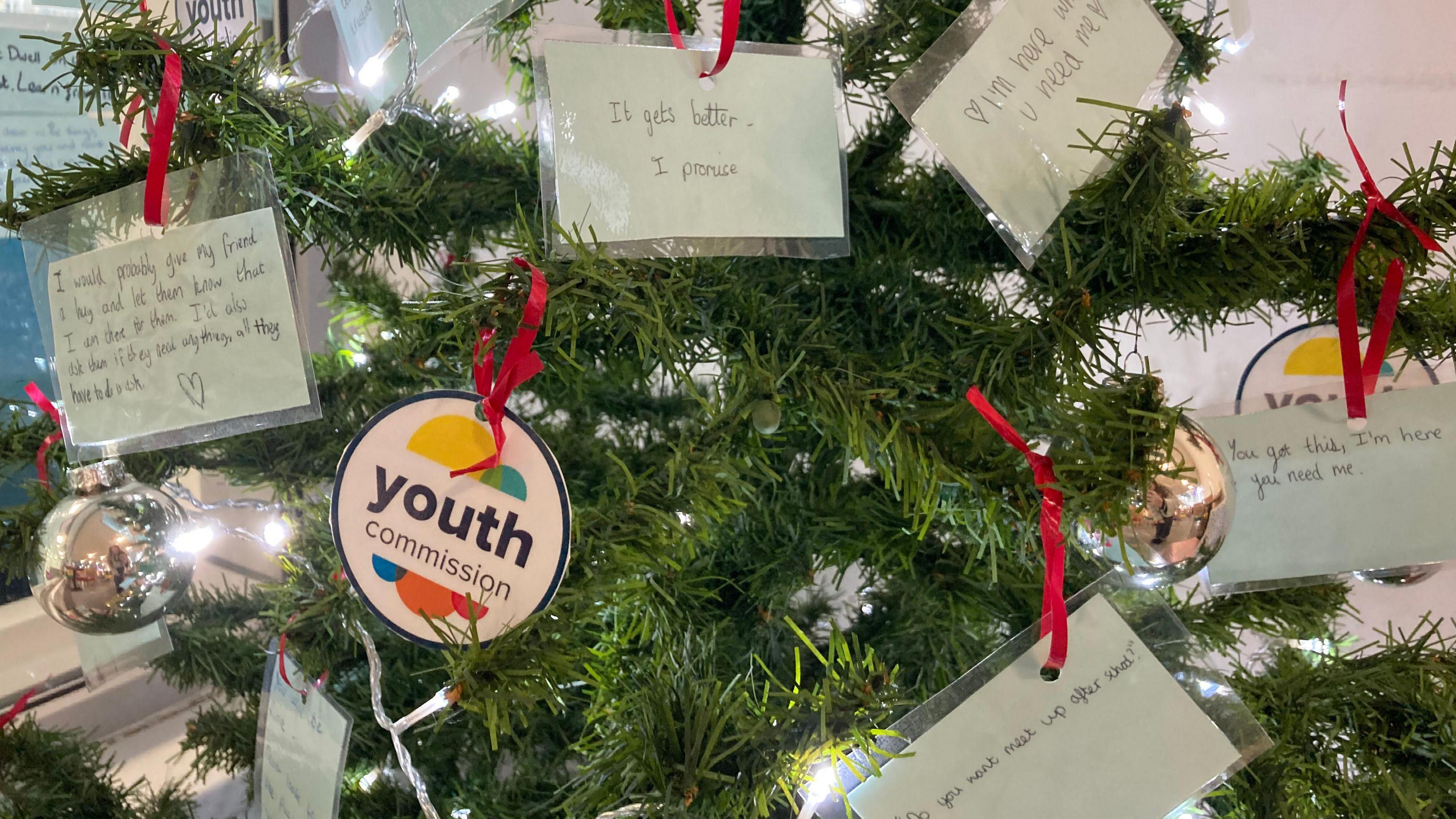 A christmas tree decorated with handwritten notes