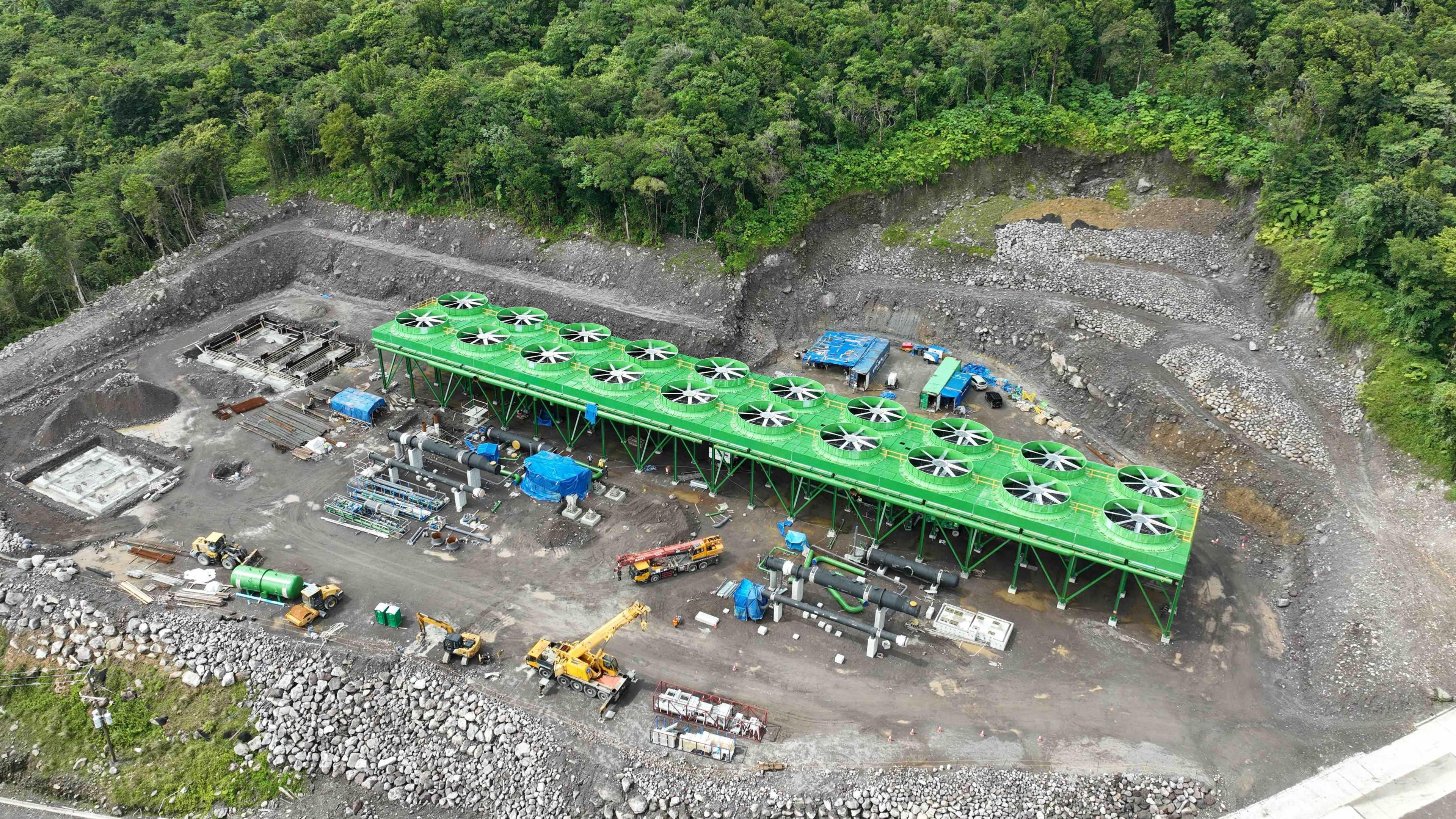 The geothermal power station under construction in a remote forested area